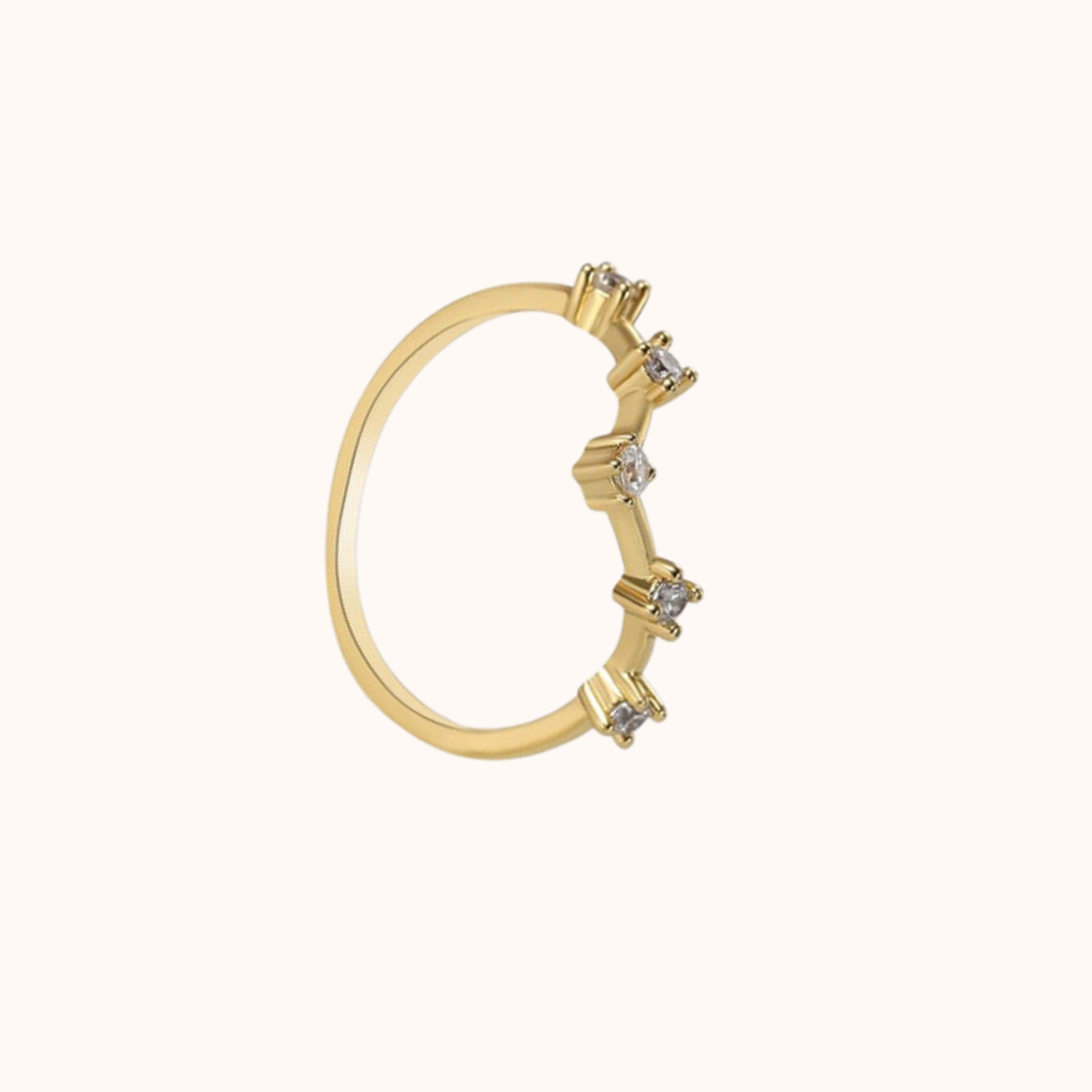 Gold ring with cubic zirconia accents on a white background