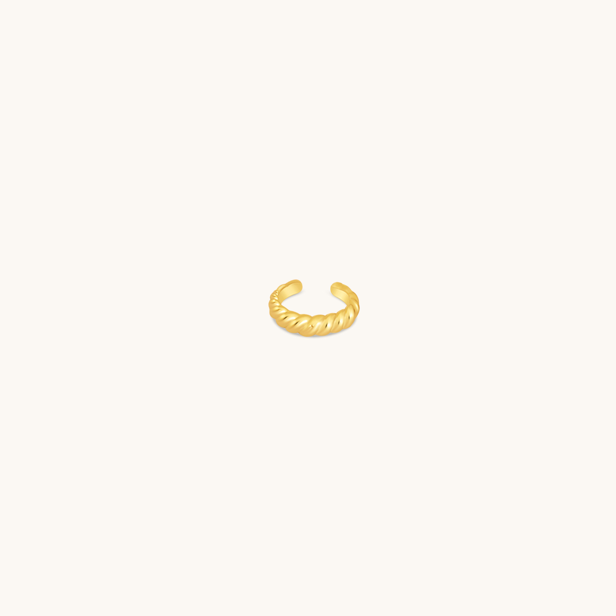 Gold croissant dome ear cuff shown on white background