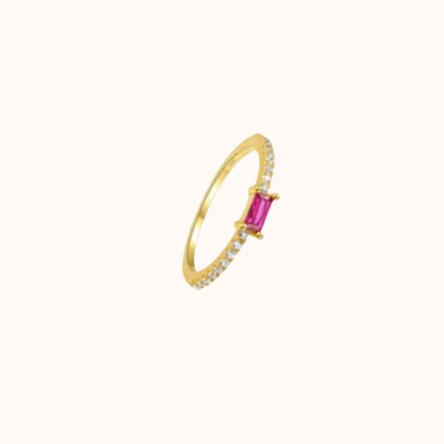 Gold ring with a pink gemstone on a white background