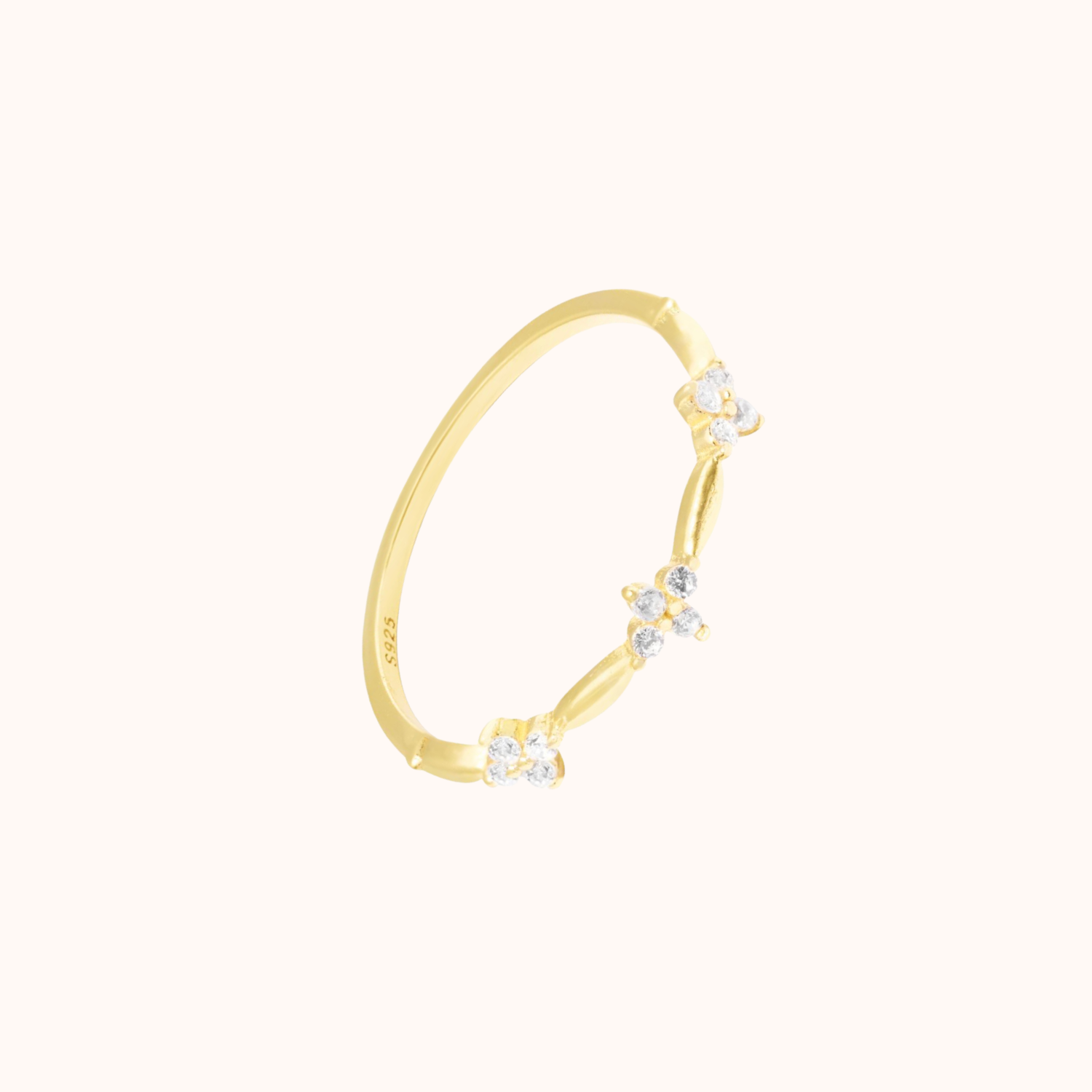 Gold ring with small cubic zirconia on a white background