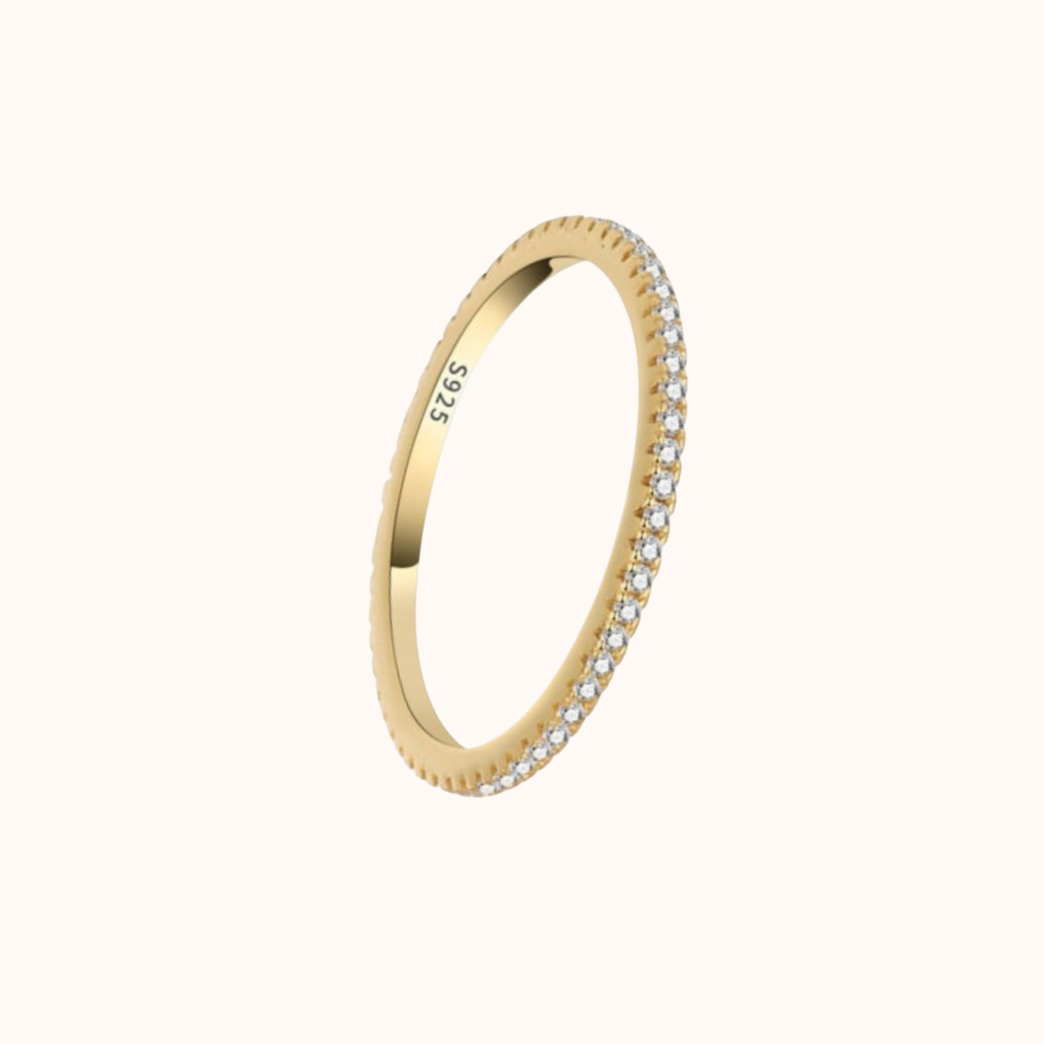 Gold ring with small cubic zirconias on a white background