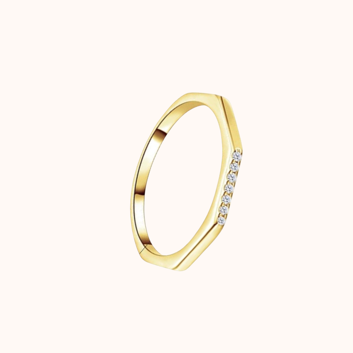 Gold ring with small CZ on a white background