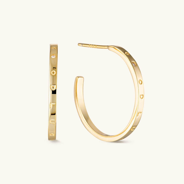 Gold decorative hoop earrings with elegant detailing and a timeless design. A chic and versatile accessory perfect for any occasion