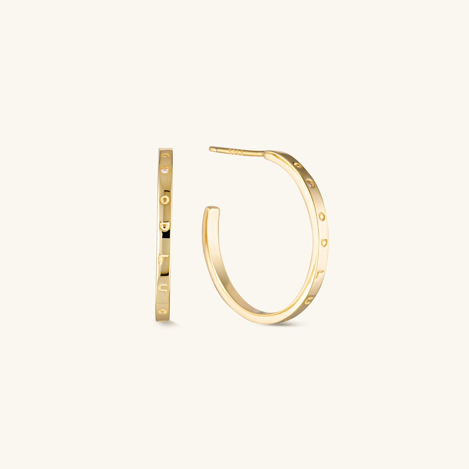 Gold decorative hoop earrings with elegant detailing and a timeless design. A chic and versatile accessory perfect for any occasion