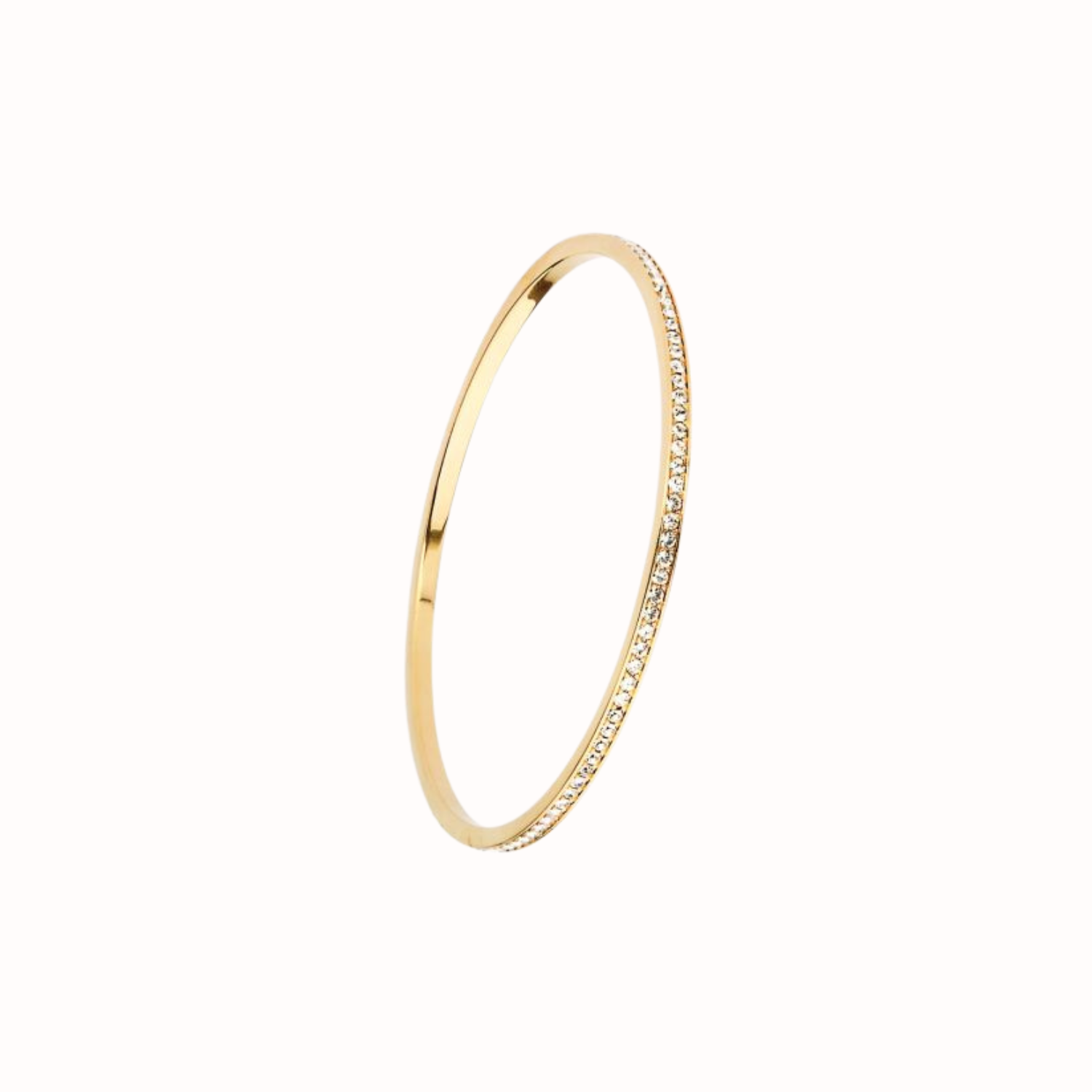 Gold bangle with small crystals on a white background
