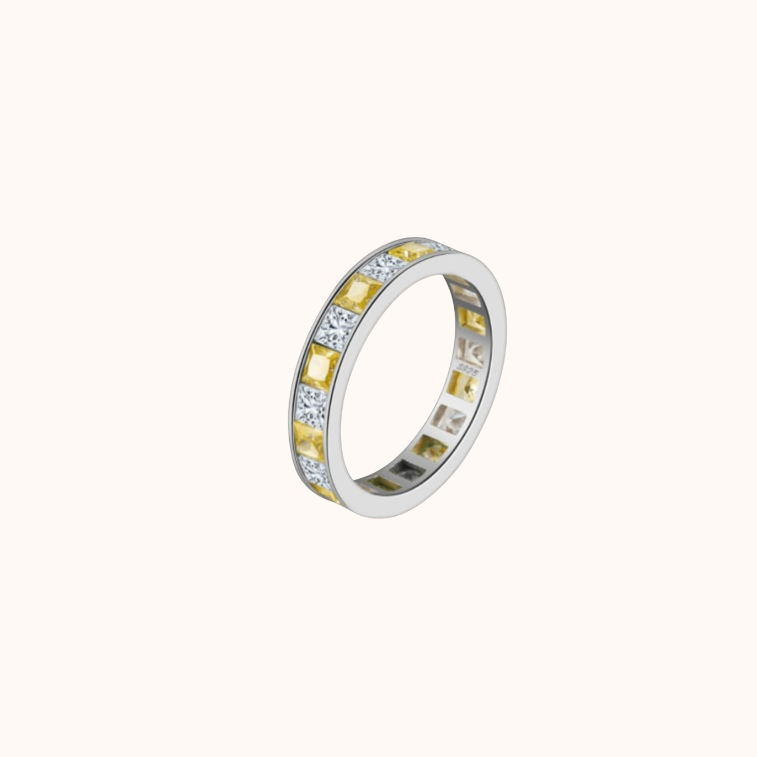 Silver ring with embedded yellow and clear gemstones on a white background