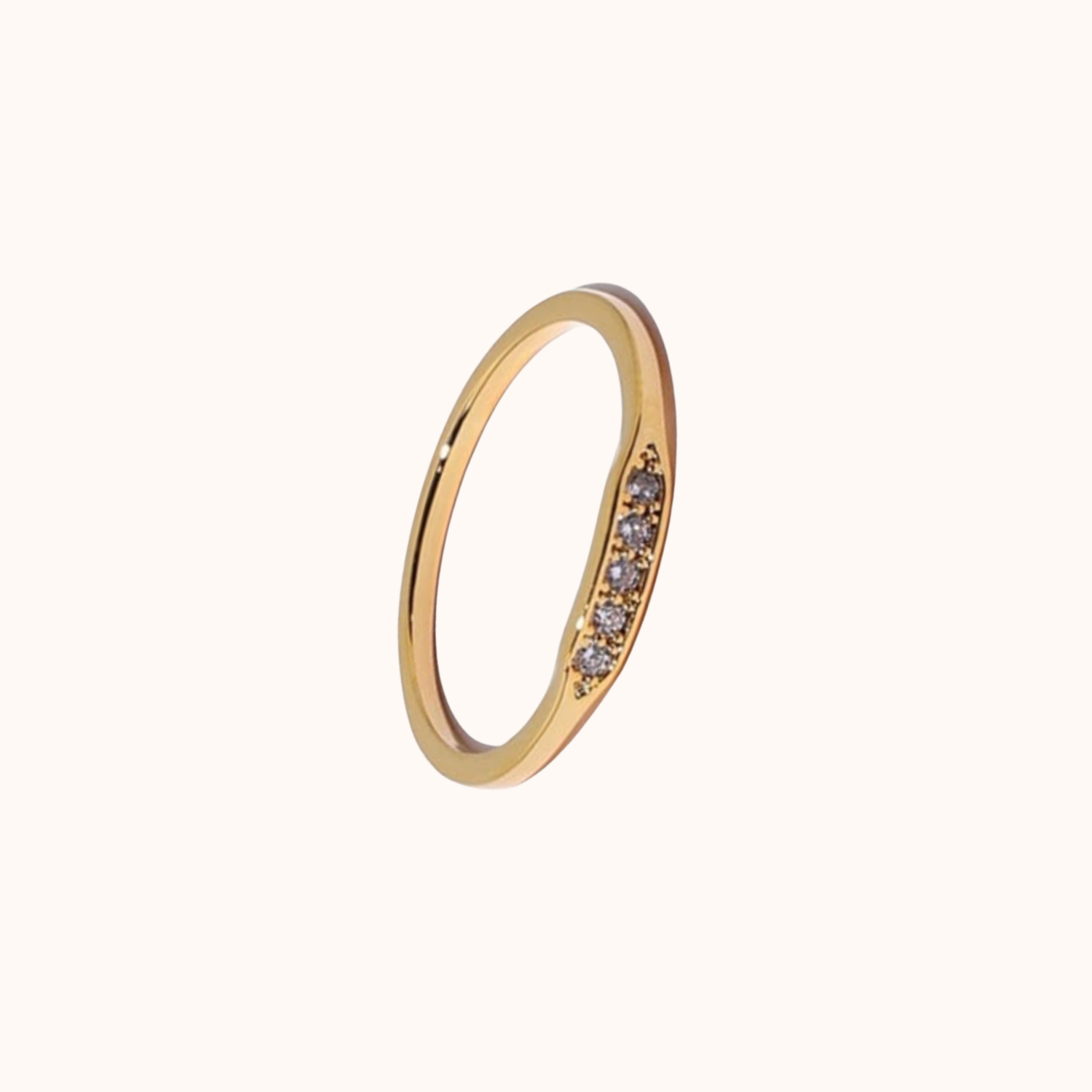 Gold ring with small CZ on a white background