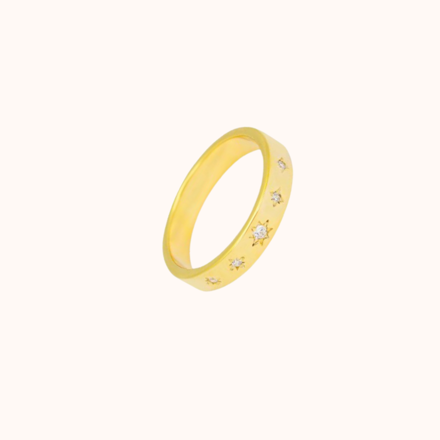Gold ring with embedded CZ on a white background