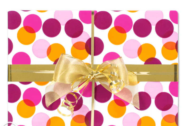 Gift box with colorful polka dot pattern and gold bow