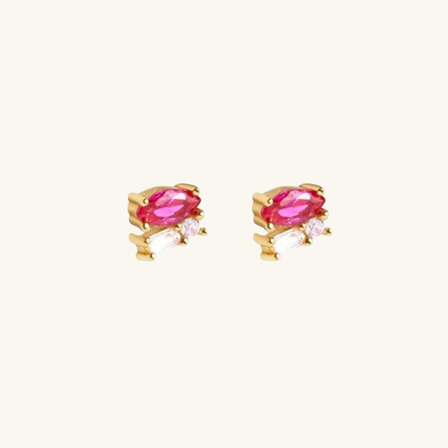 Gold earrings with pink cubic zirconia on a white background