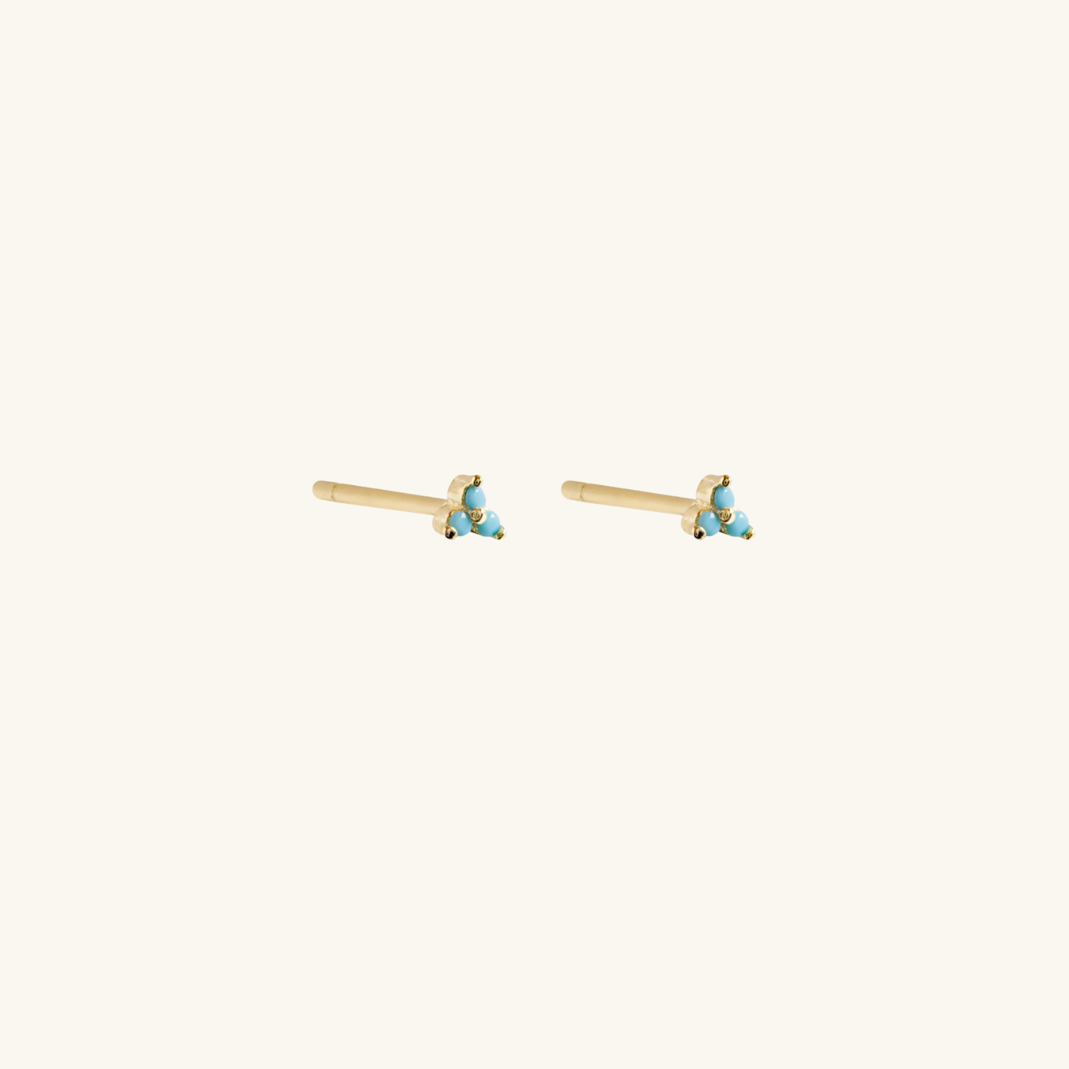 Blue lotus earrings on  cream background