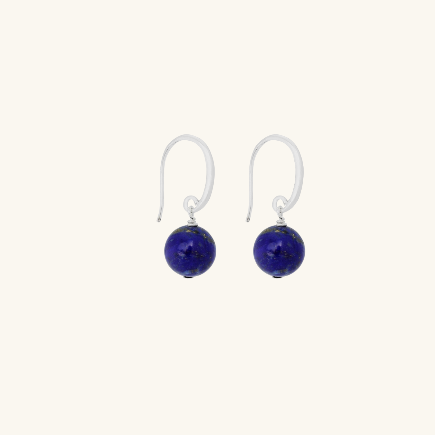 Pair of Lapis earrings with blue spherical beads on white background