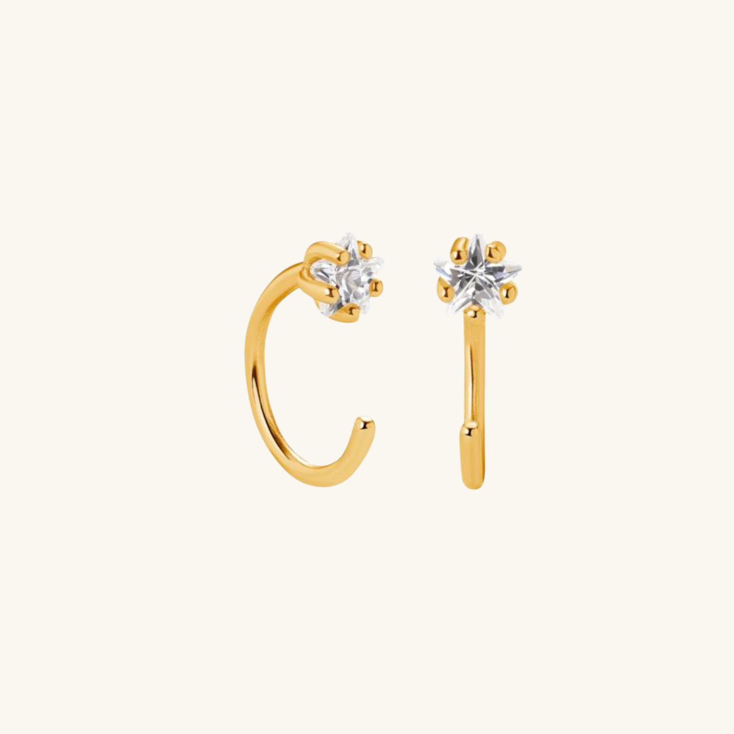 Gold hoop earrings with star-shaped cubic zirconia on a white background