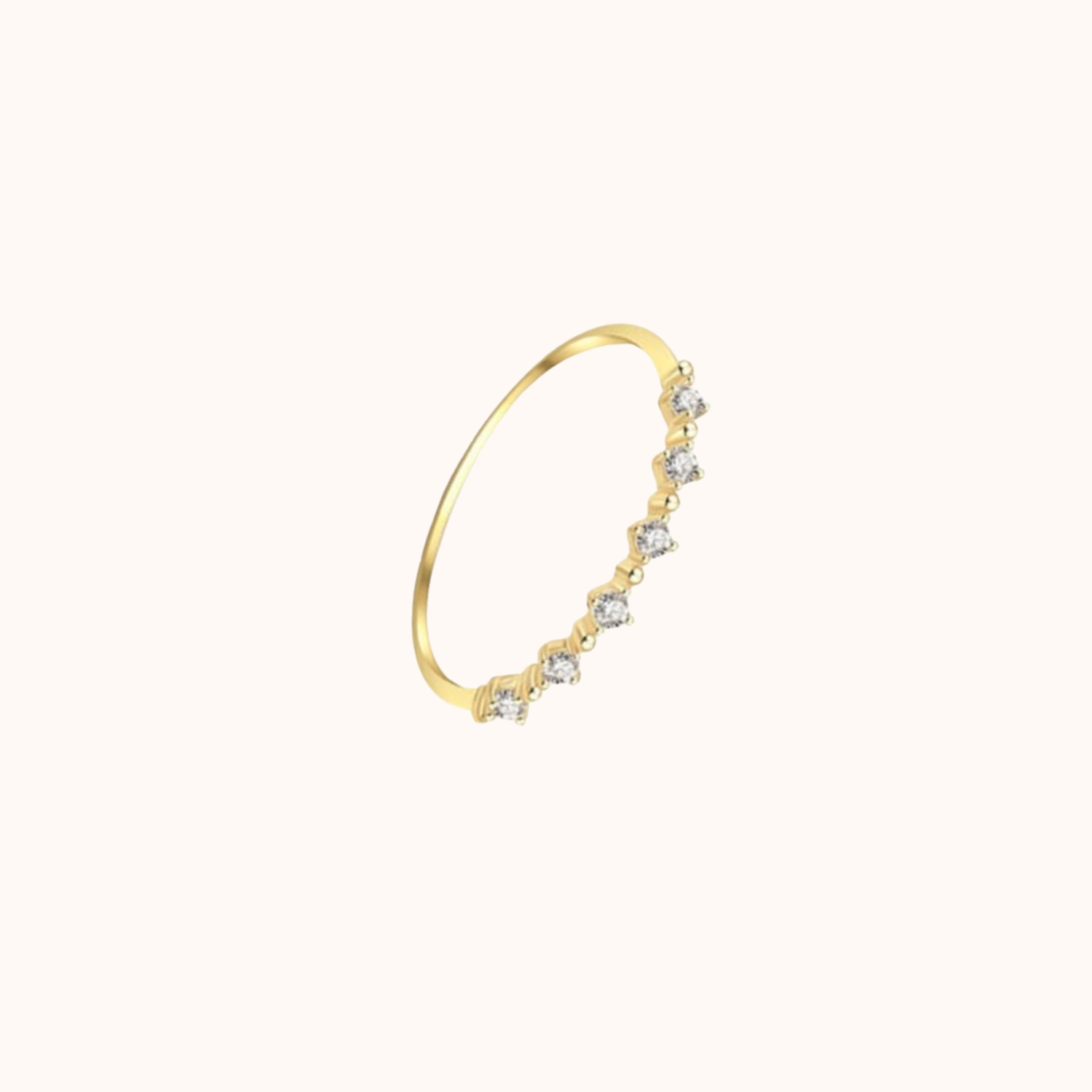 Gold ring with small cubic zirconias on a white background