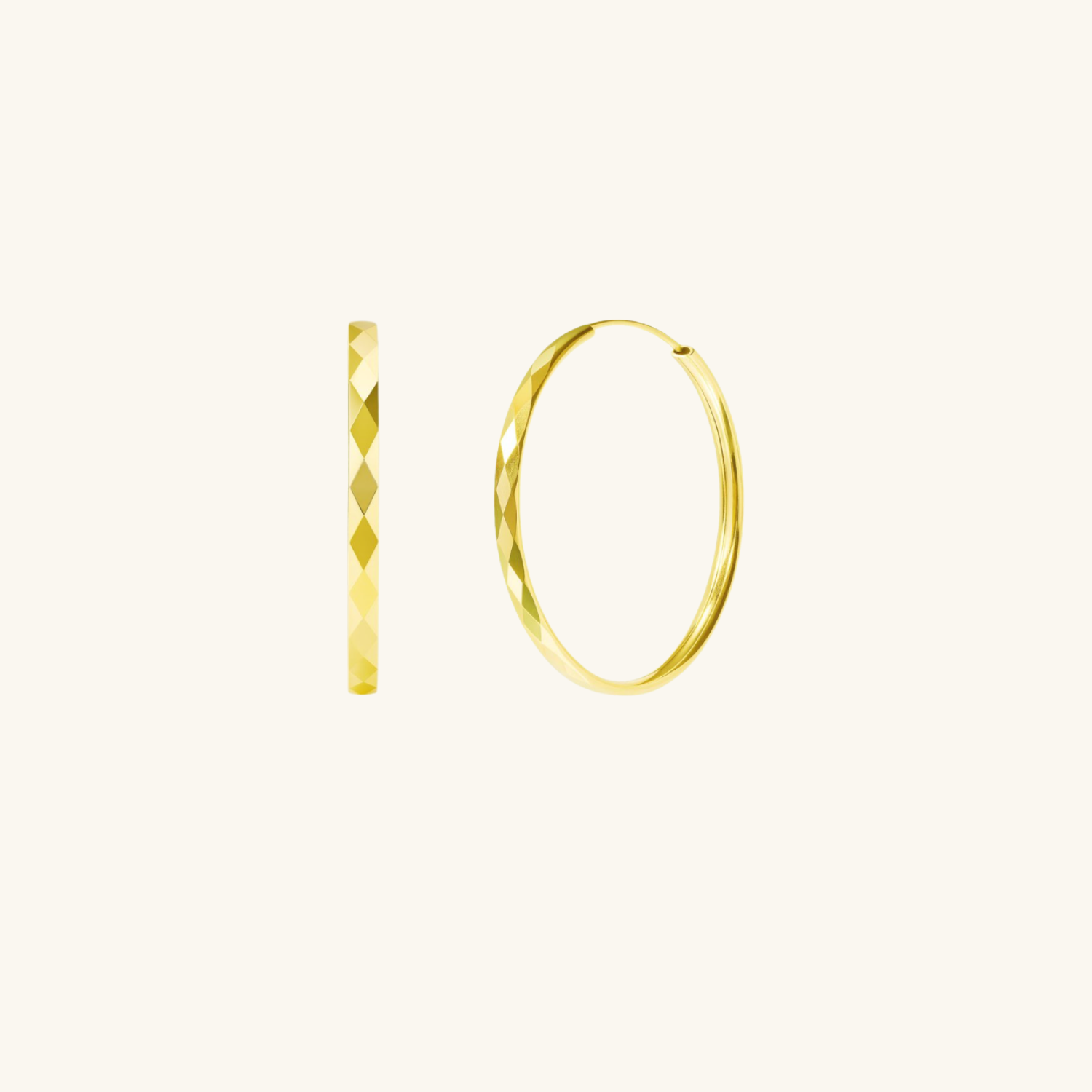 Gold plated hammered look hoops on cream background