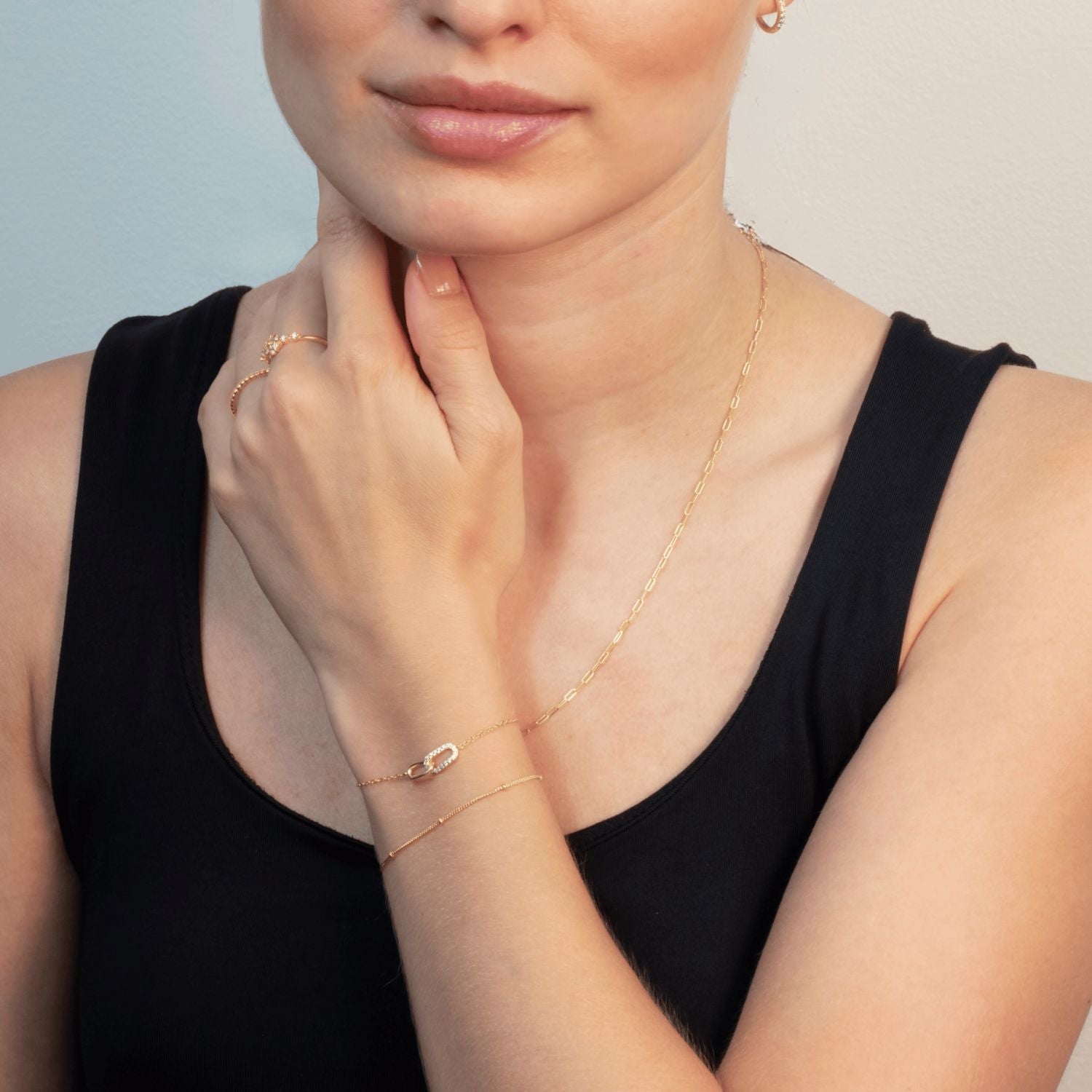 Model wearing gold plated link bracelet with cubic zirconia – elegant interlocking design symbolising connection and sparkle.