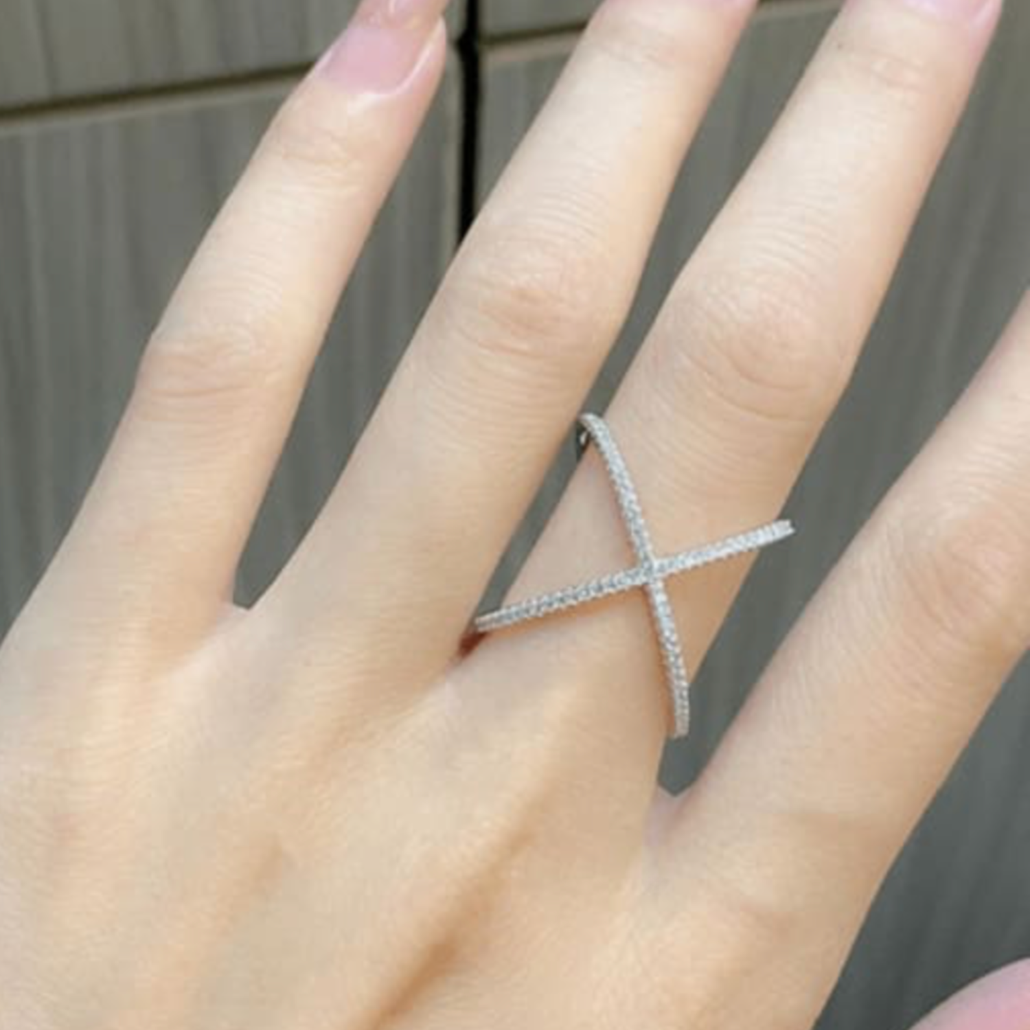 Model wearing stellar cross ring