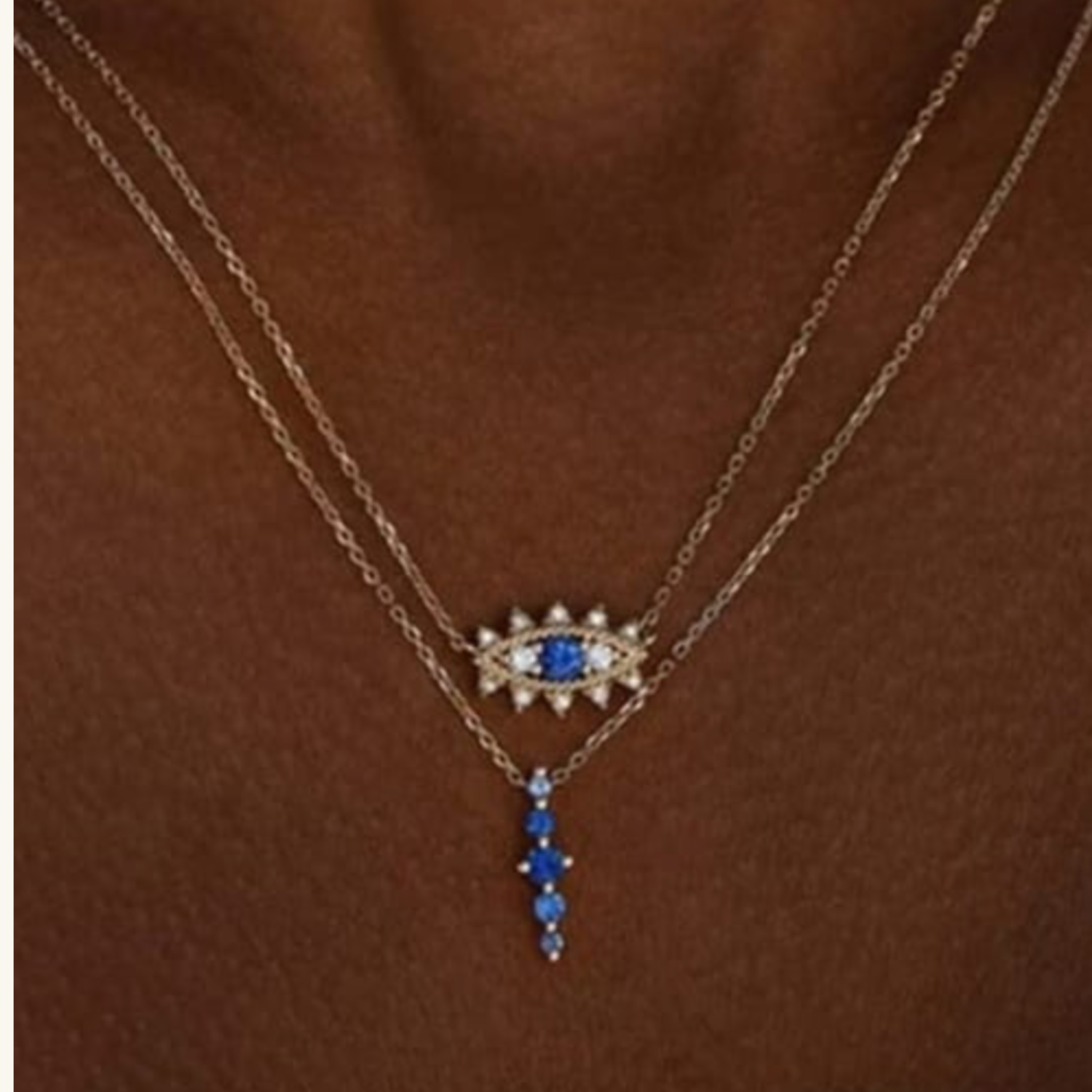 Model wearing Gold necklace with blue gemstone pendant 