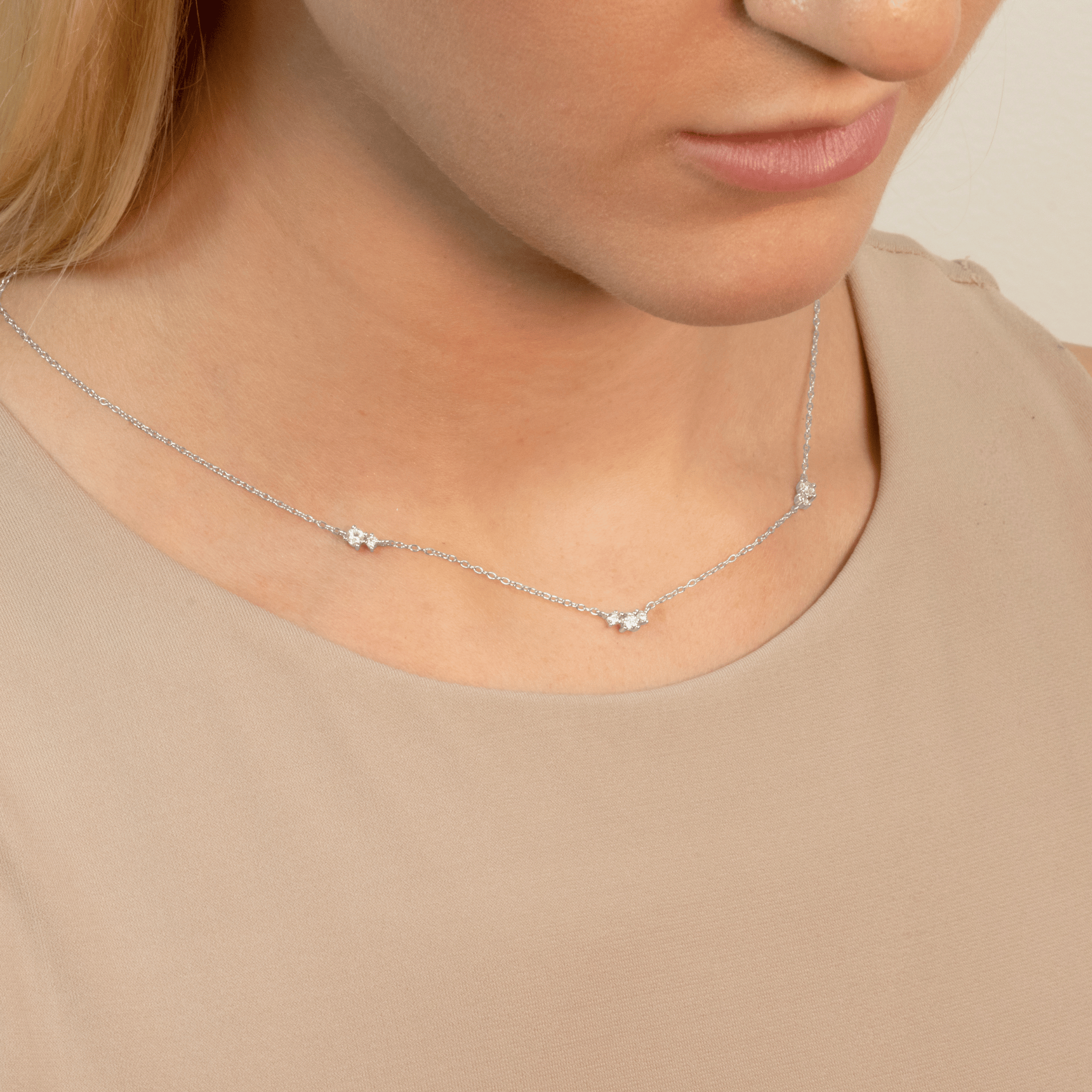 model wears silver floating cubic zirconia necklace