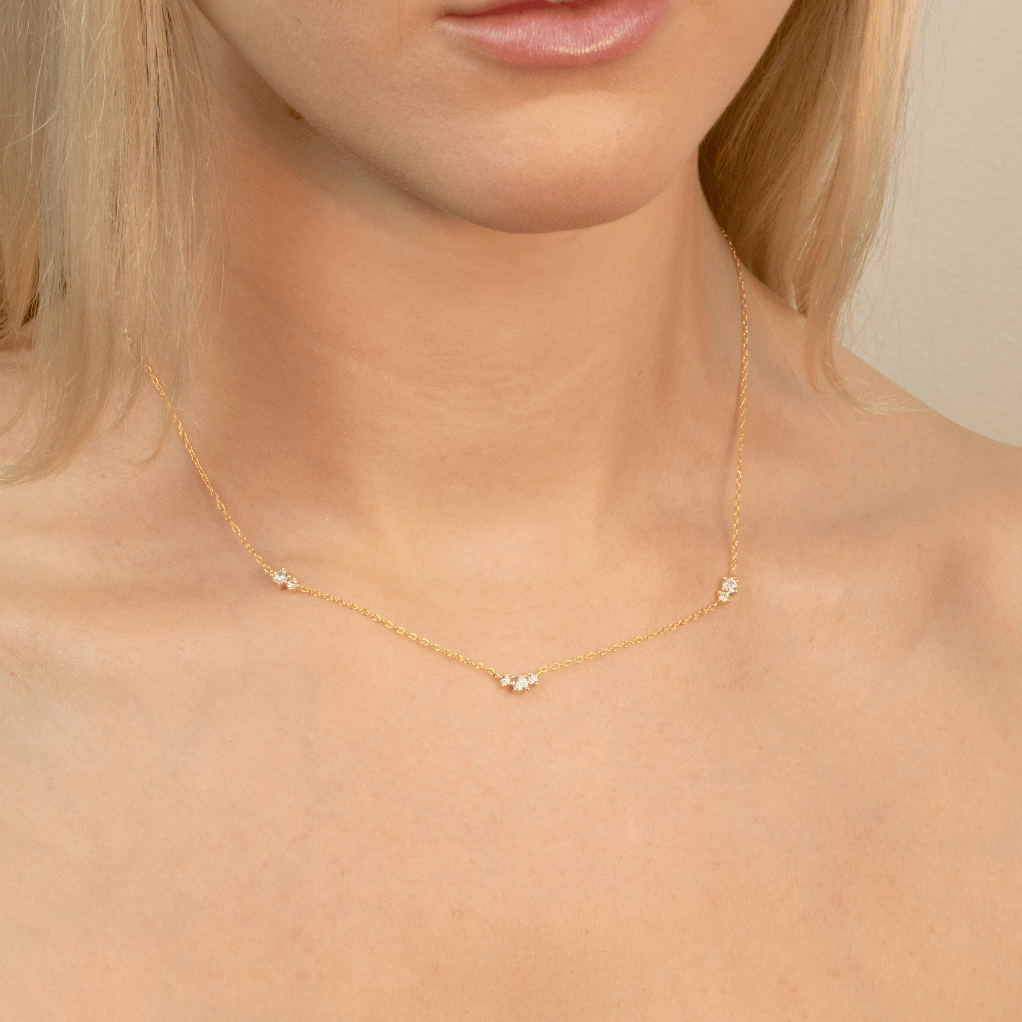 model wears gold floating cubic zirconia necklace