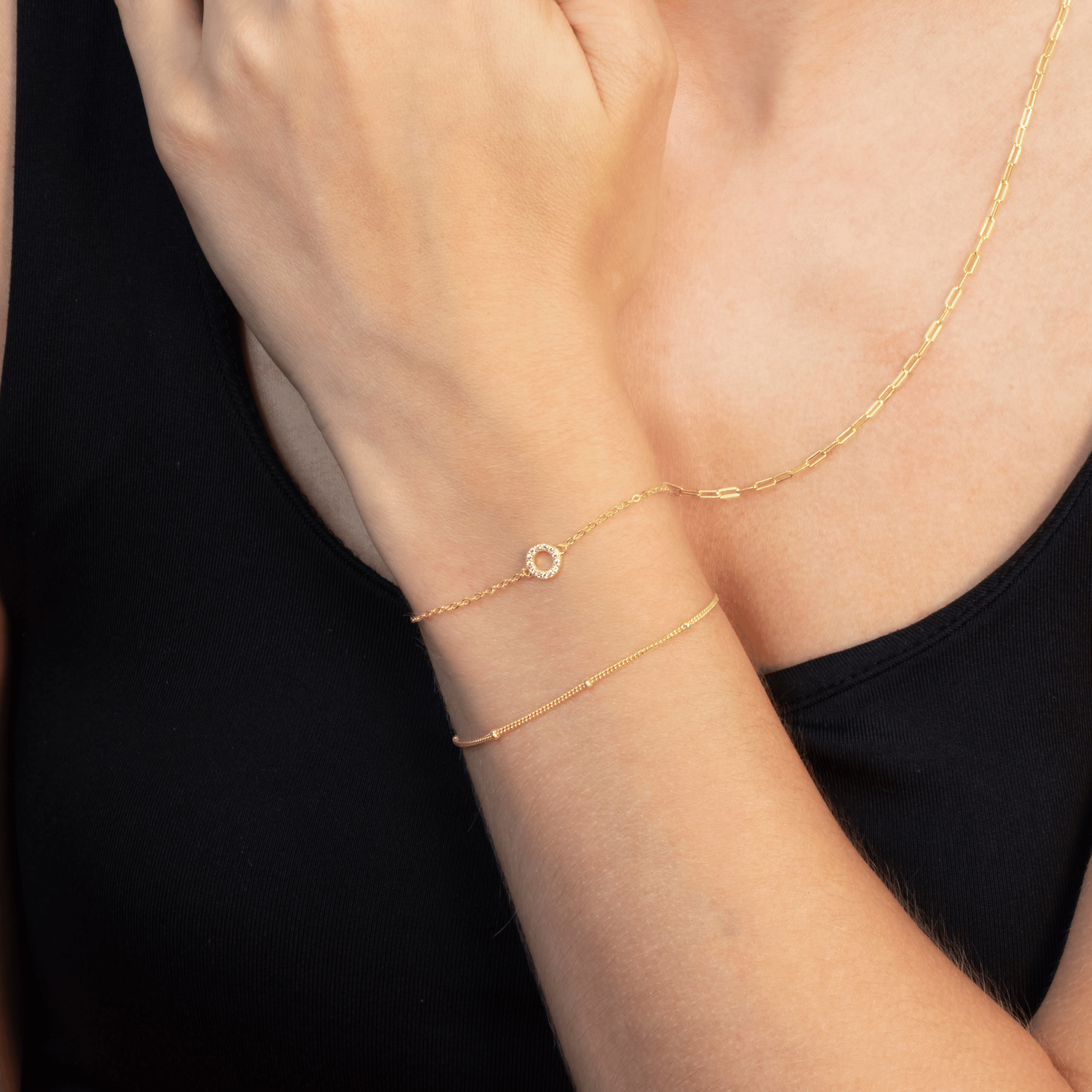 Model_wears_gold_circle_bracelet_with_satellite