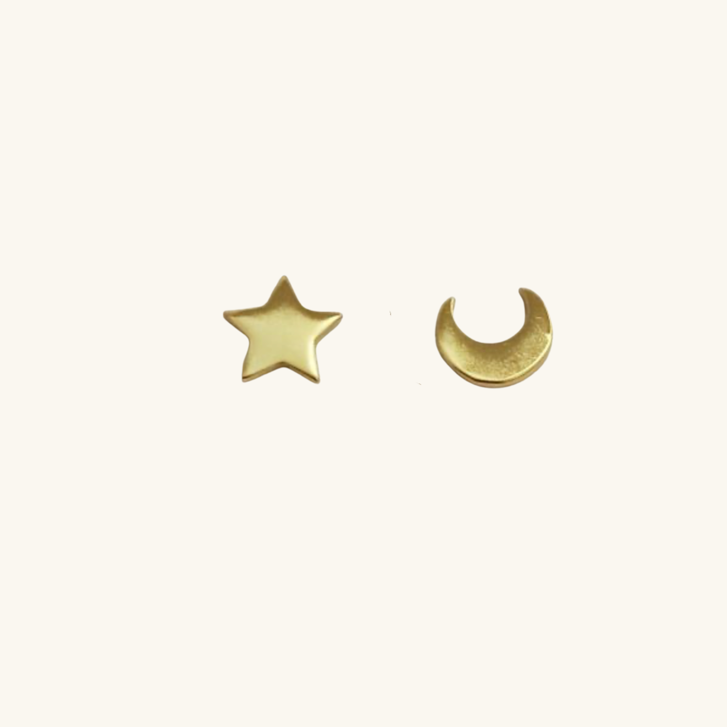 Moon and star stud earrings on a white background