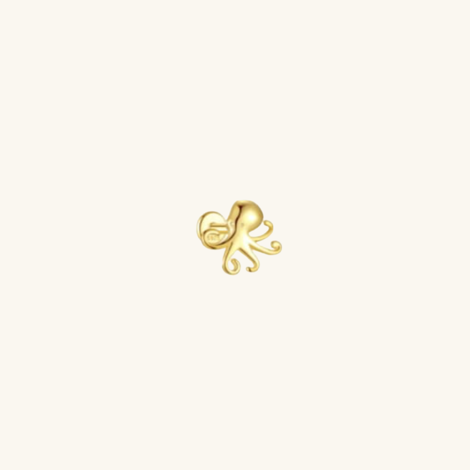 Gold octopus-shaped earring on a white background