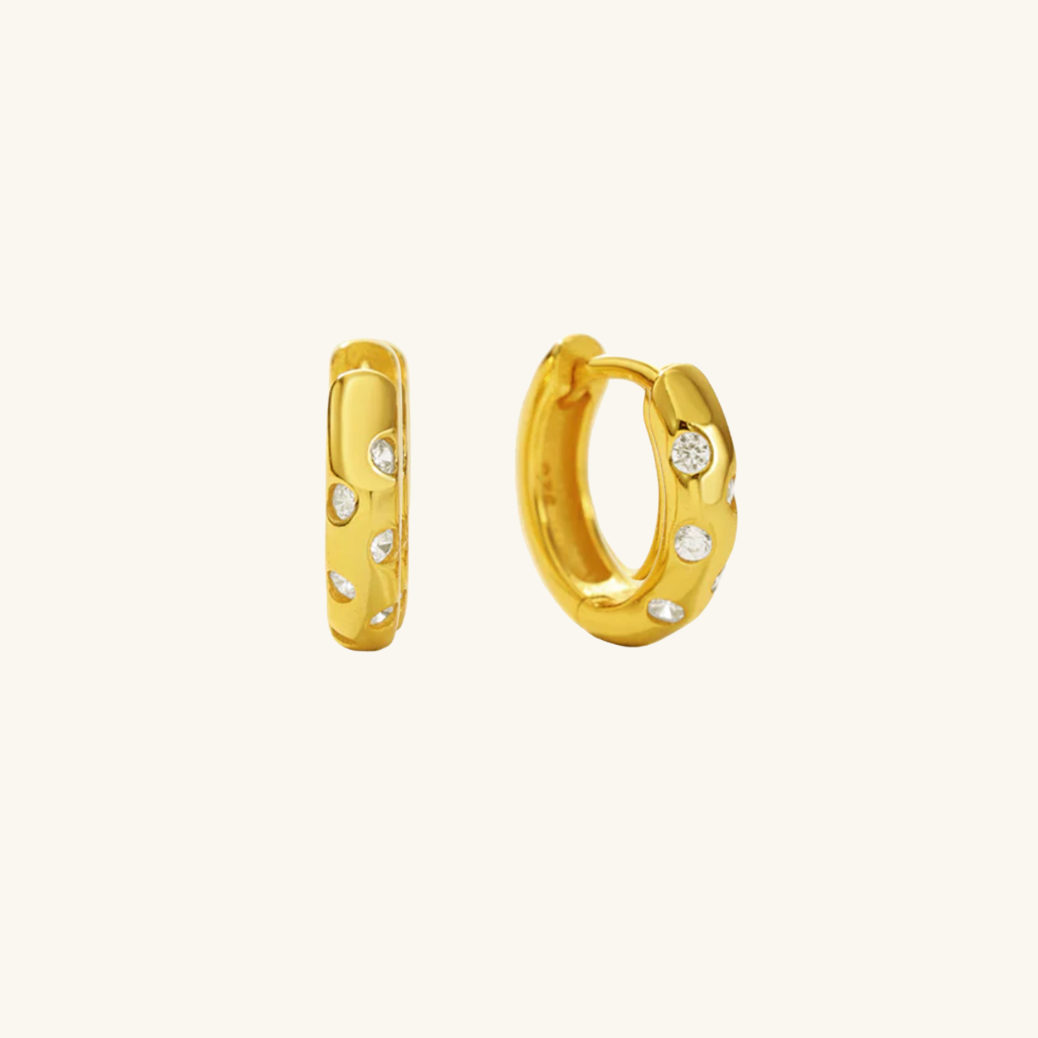 Gold hoop earrings with embedded stones on a white background
