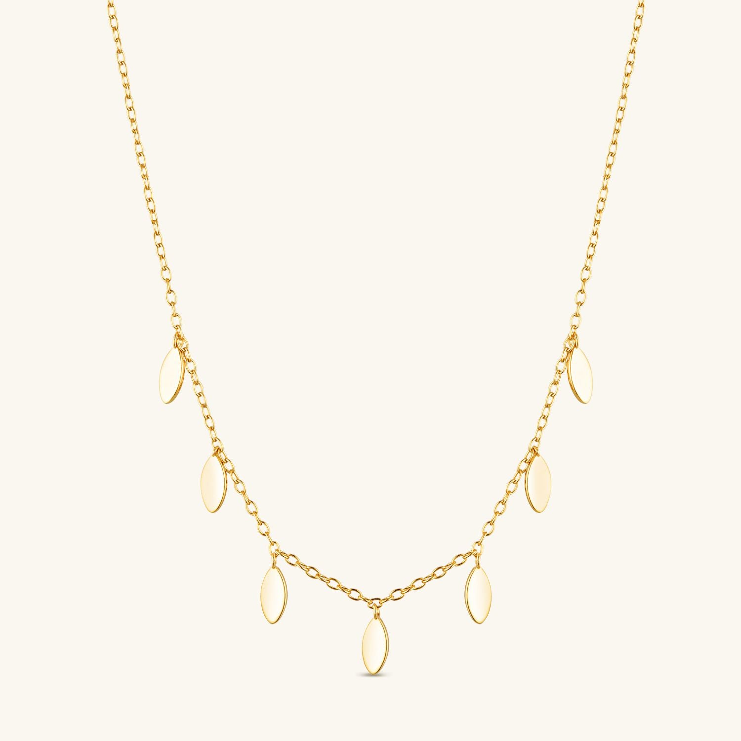 Gold chain necklace with delicate petal drops hanging along its length, featuring an elegant and feminine design perfect for layering or everyday wear