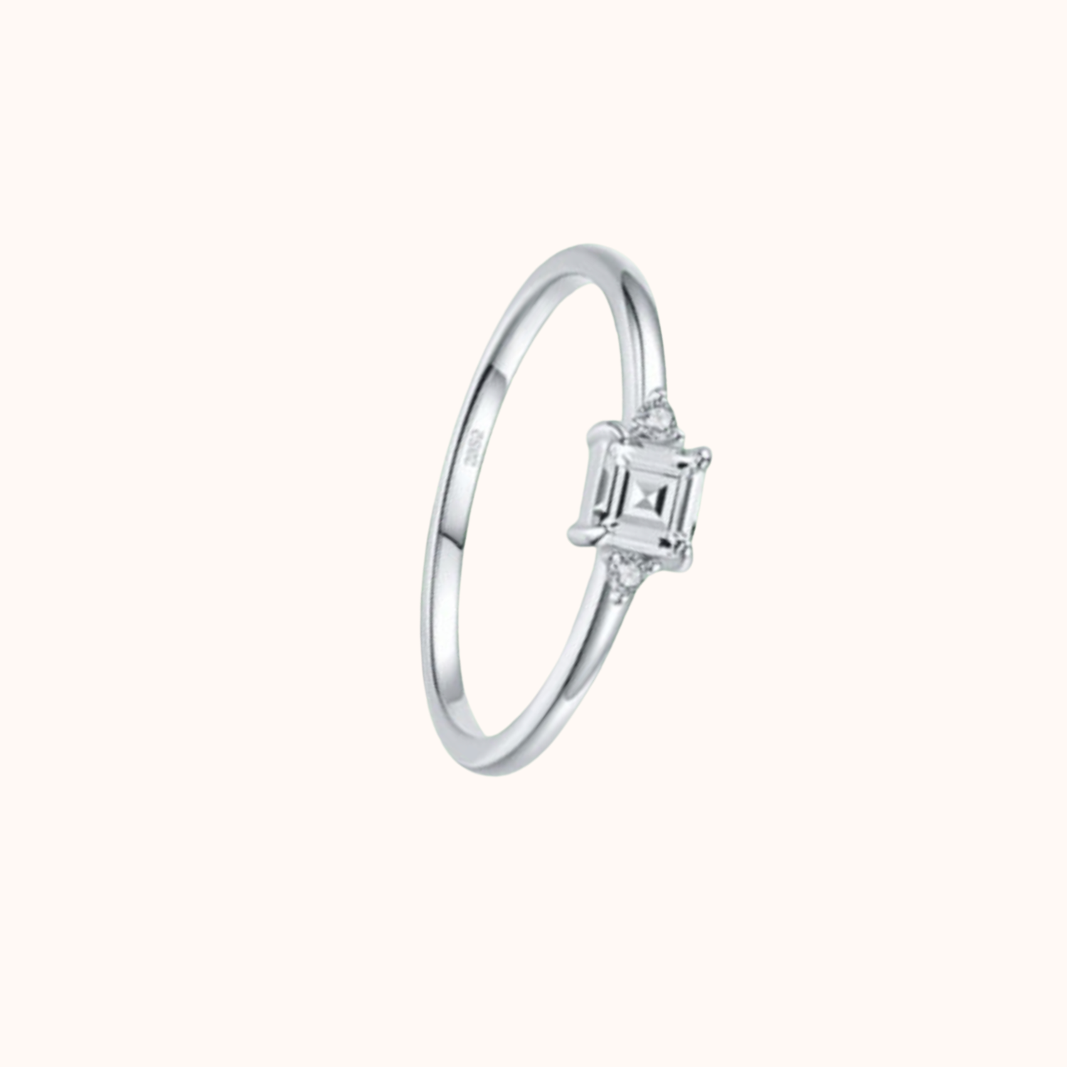 Silver ring with a CZ on a white background