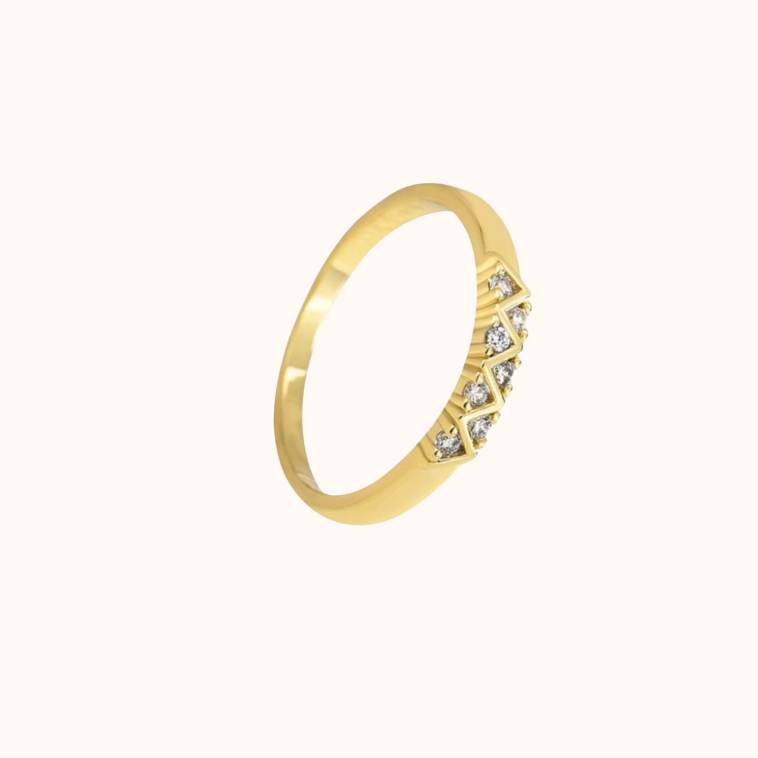 Gold ring with small CZs on a white background