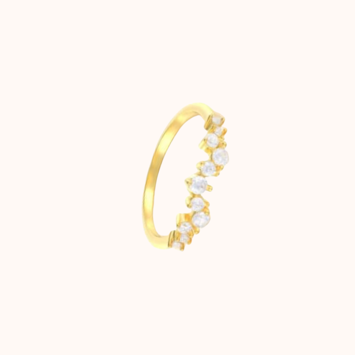Gold ring with embedded cubic zirconia on a white background