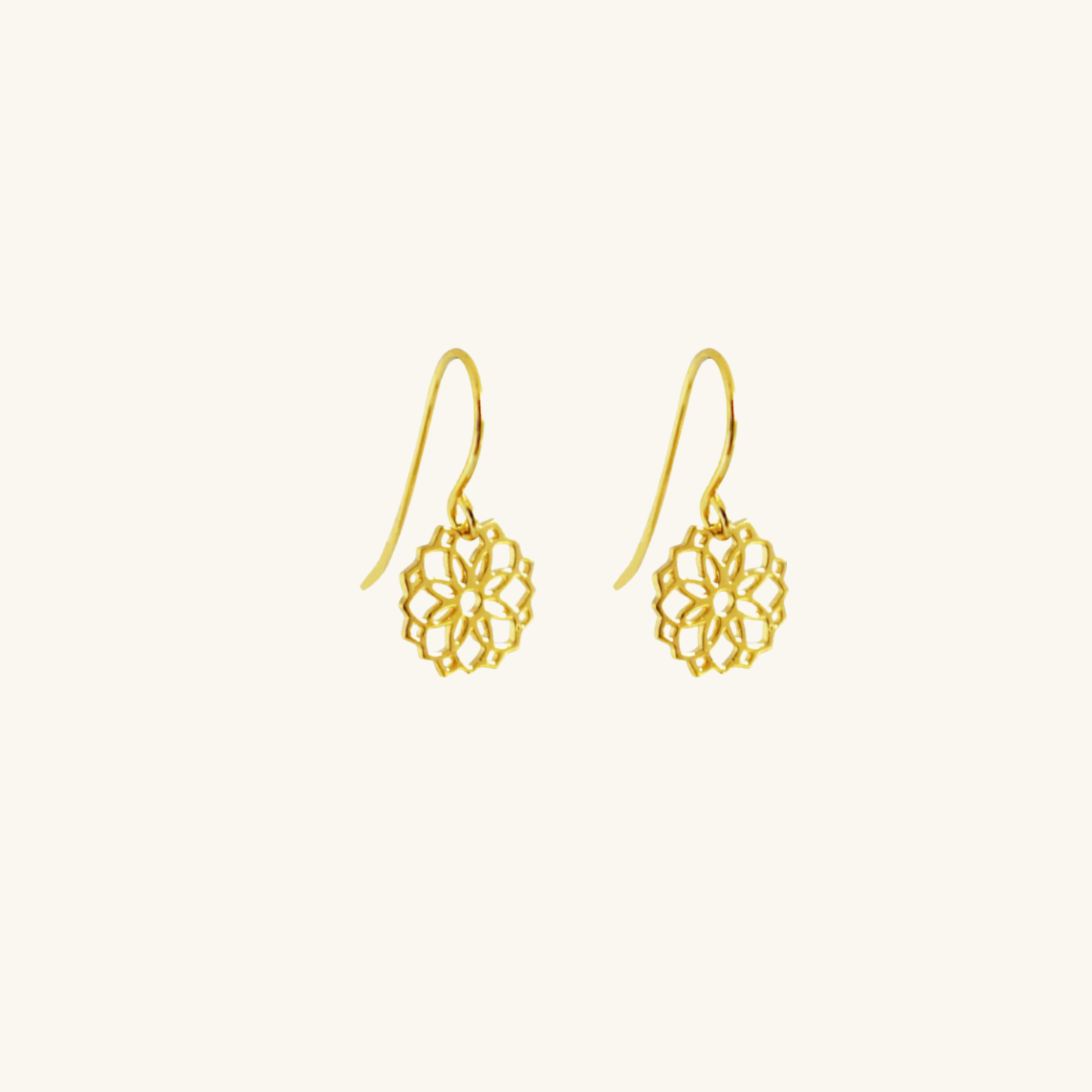 Pair of gold floral earrings on a white background