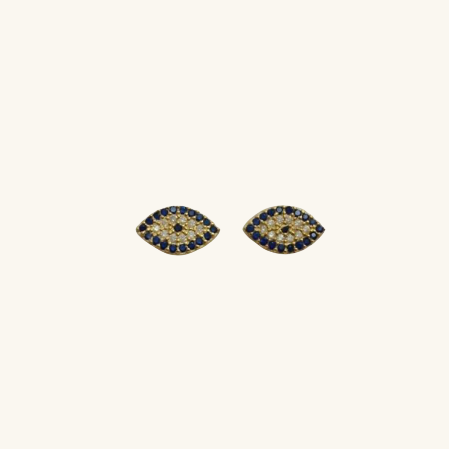 Pair of gold Evil Eye earrings with blue gemstones on a white background
