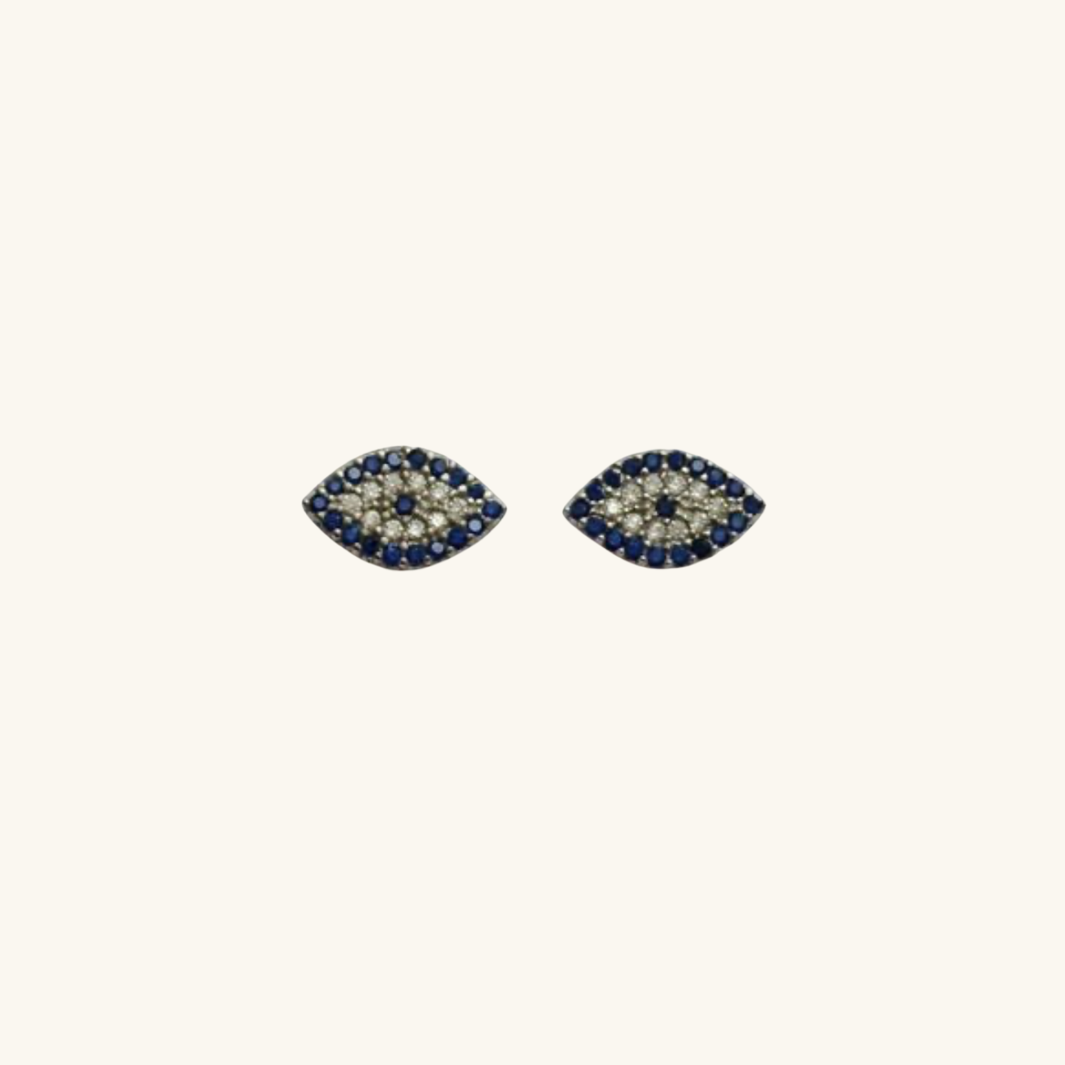 Pair of Silver Evil Eye earrings with blue and clear stones on a white background