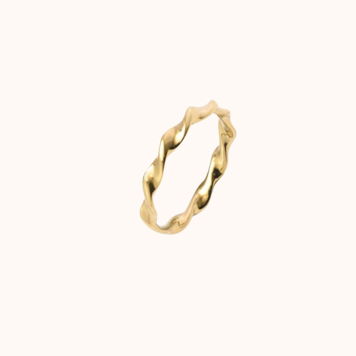 Gold ring with a wavy design on a white background