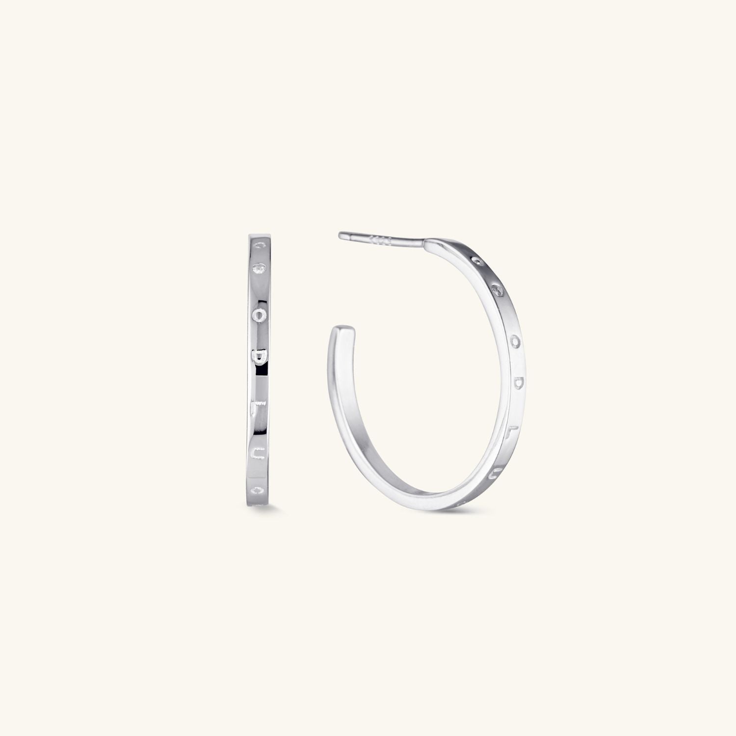 Silver decorative hoop earrings with intricate detailing and a timeless design. A stylish and versatile accessory for any occasion
