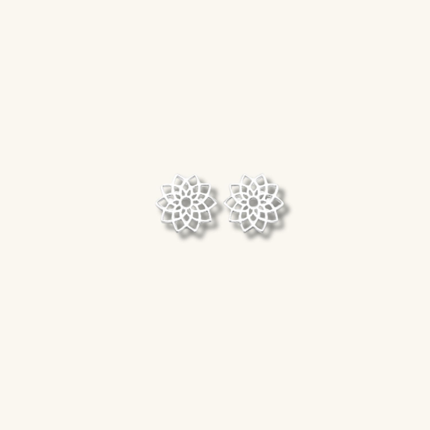 Silver bloom studs on a cream background