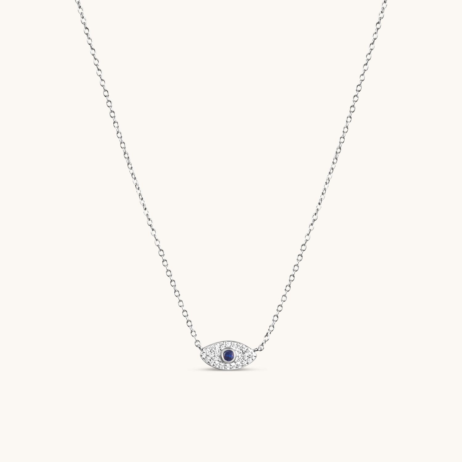 Silver evil eye necklace with a sleek, polished charm on a delicate chain, symbolizing protection and timeless elegance