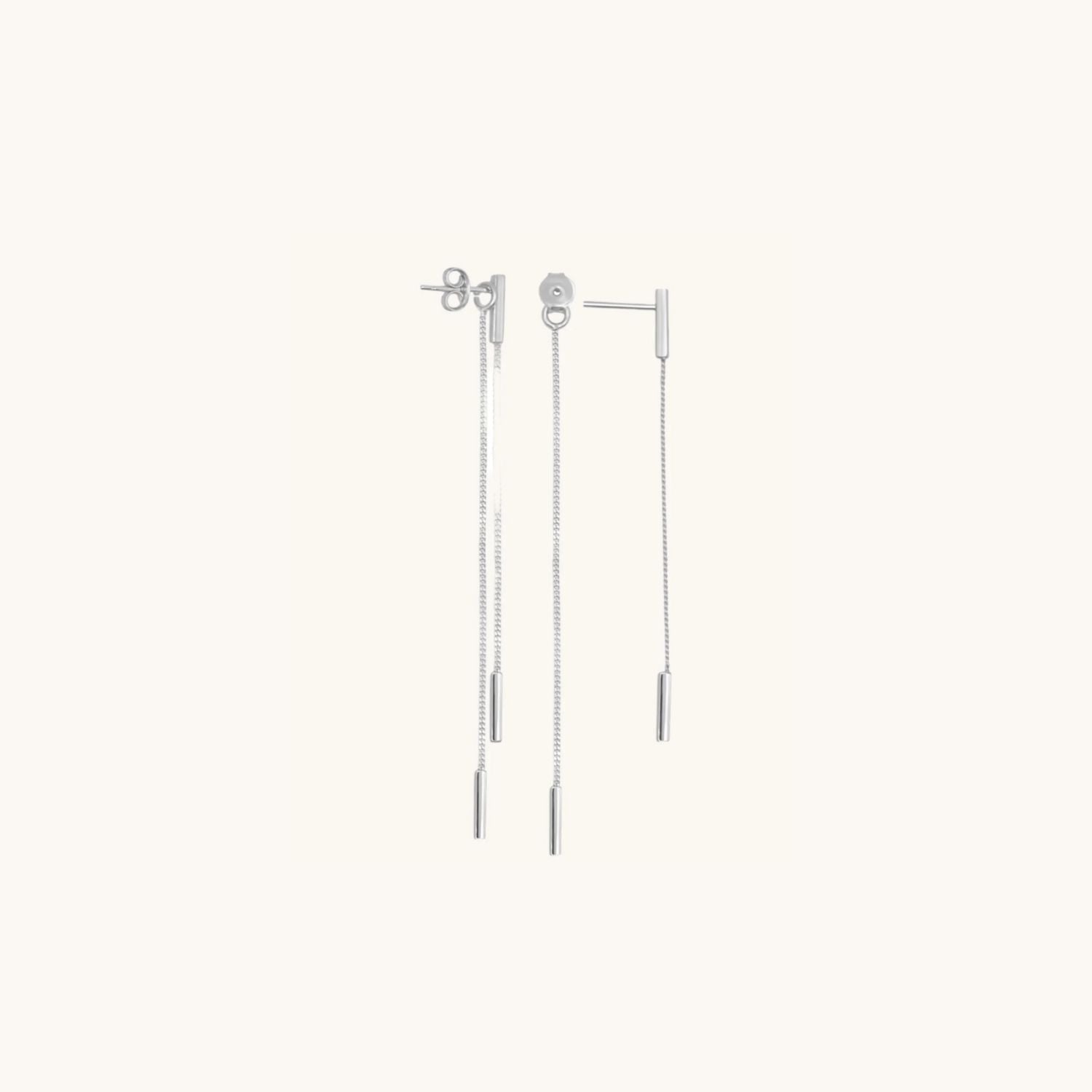 Sterling silver thread and rectangle drop earrings with butterfly backs, shown on cream background