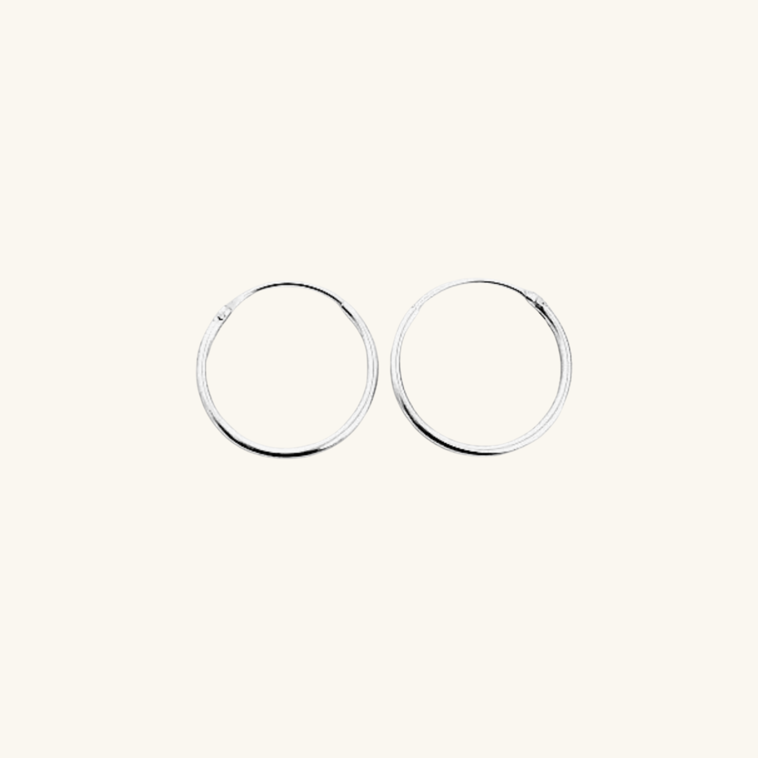 Two silver hoop earrings on a white background