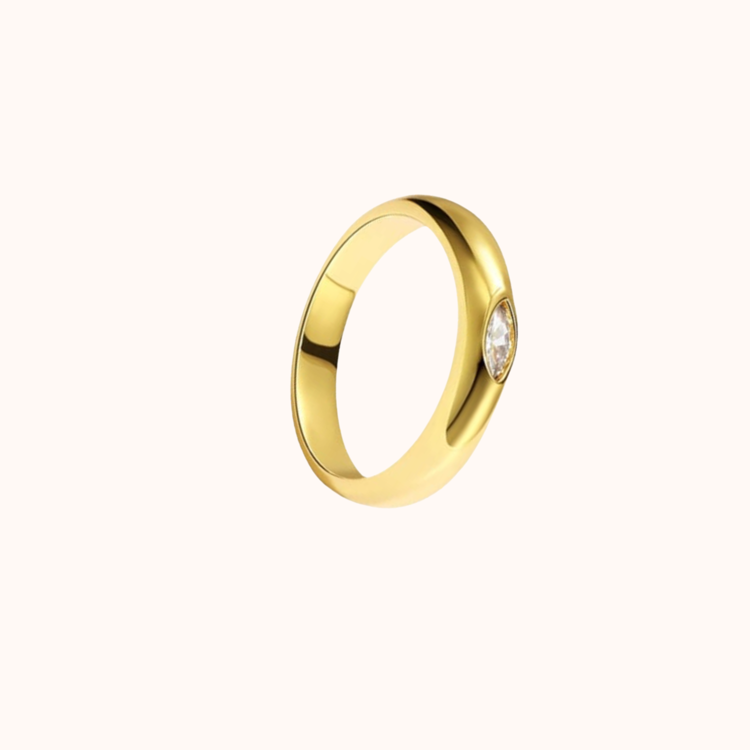 single stone brass ring on cream background