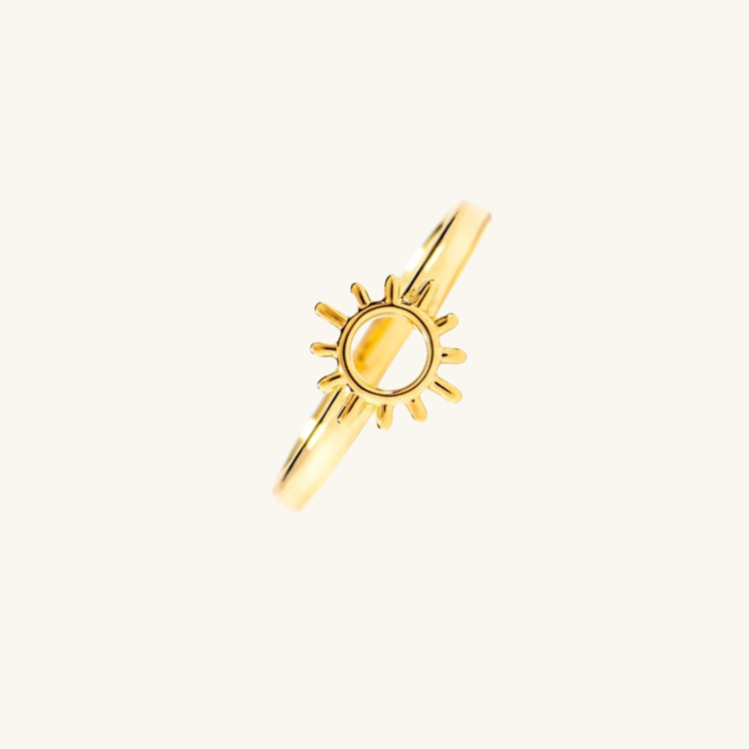 Gold sun-shaped pendant on a white background