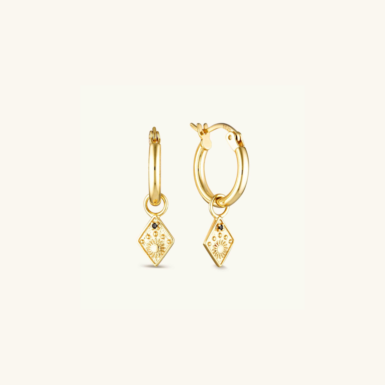 Gold-plated Solstice Huggie Earrings with a diamond-shaped drop, featuring a radiant sun emblem and star for a celestial-inspired look