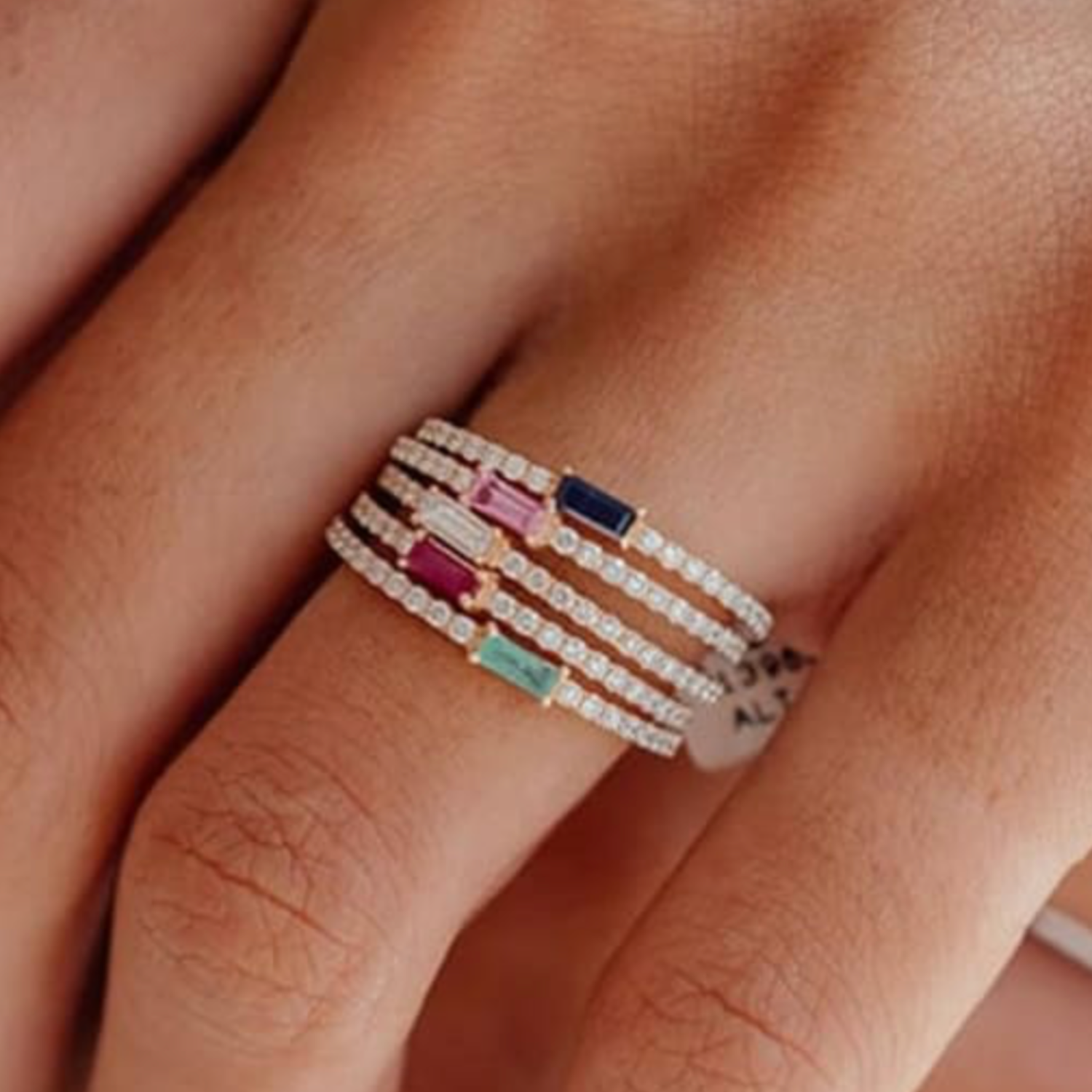 Stack of colorful rings on a finger