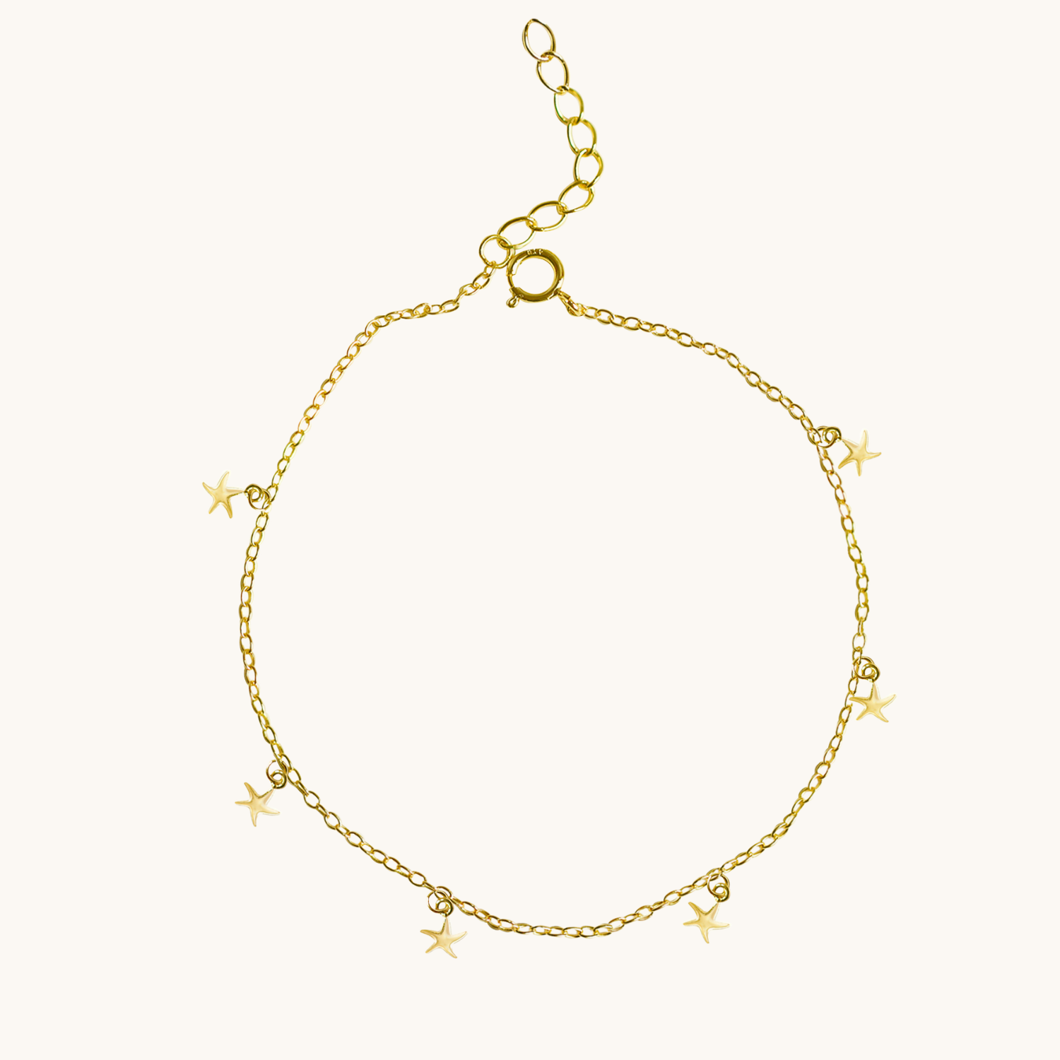 Gold bracelet with star charms on a white background