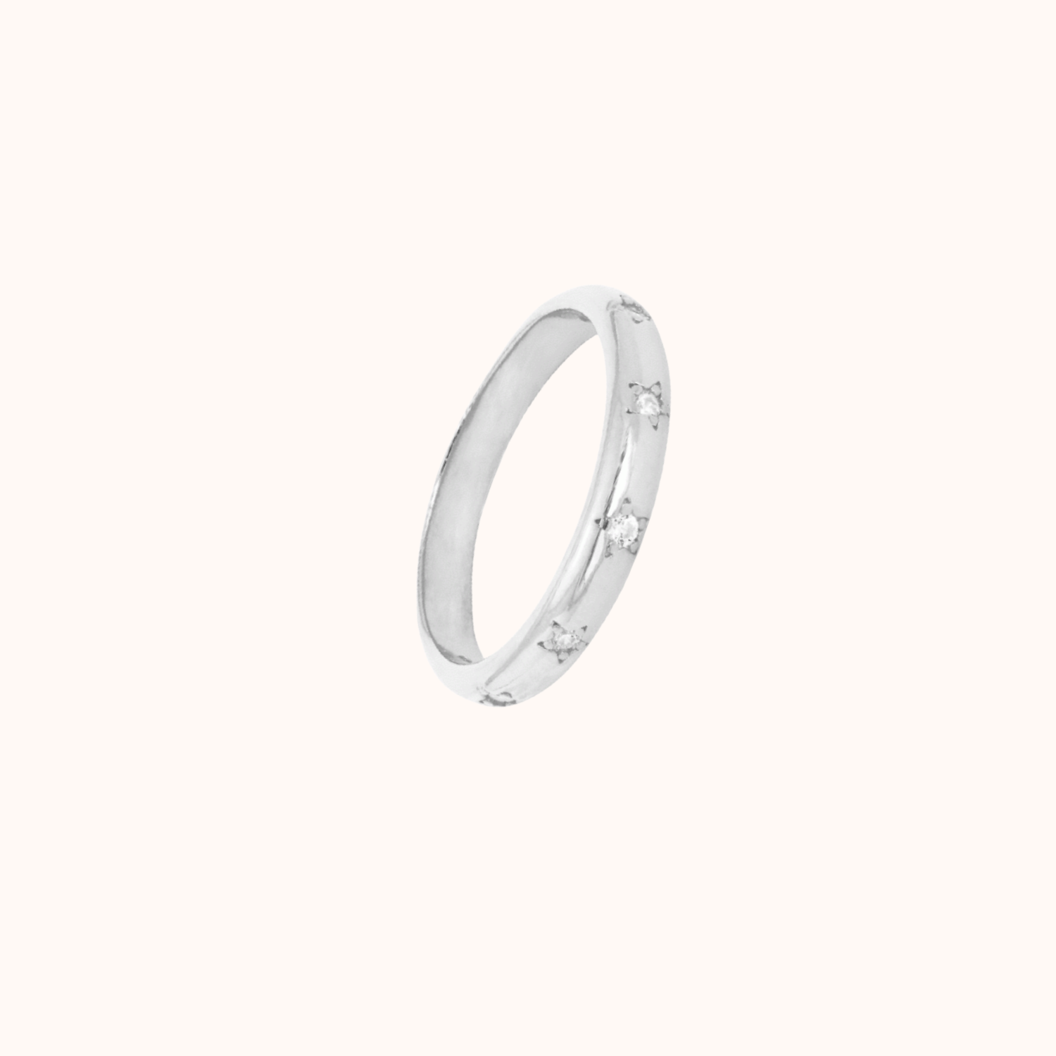 Silver ring with small cubic zirconias on a white background