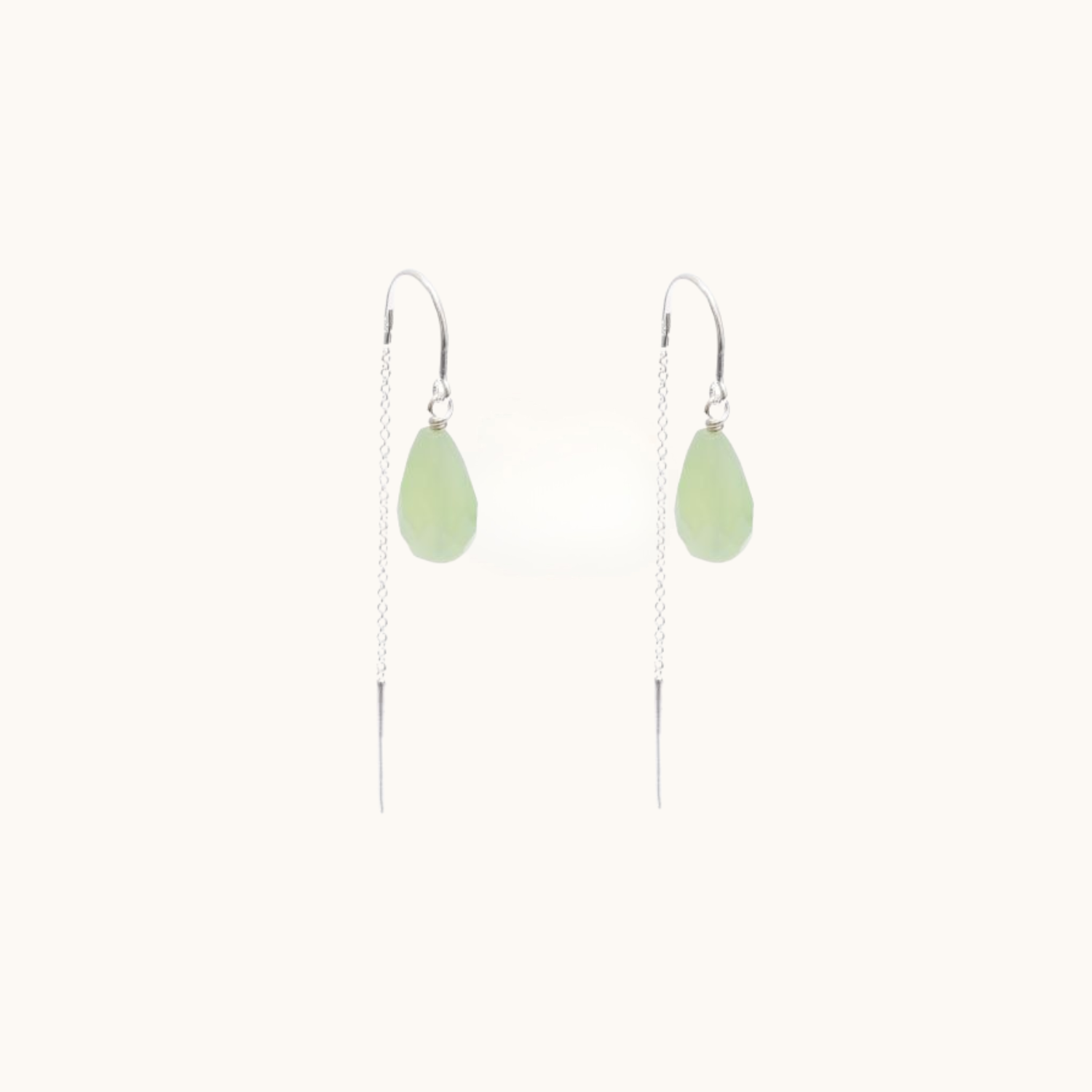 Pair of green thread earrings on a white background