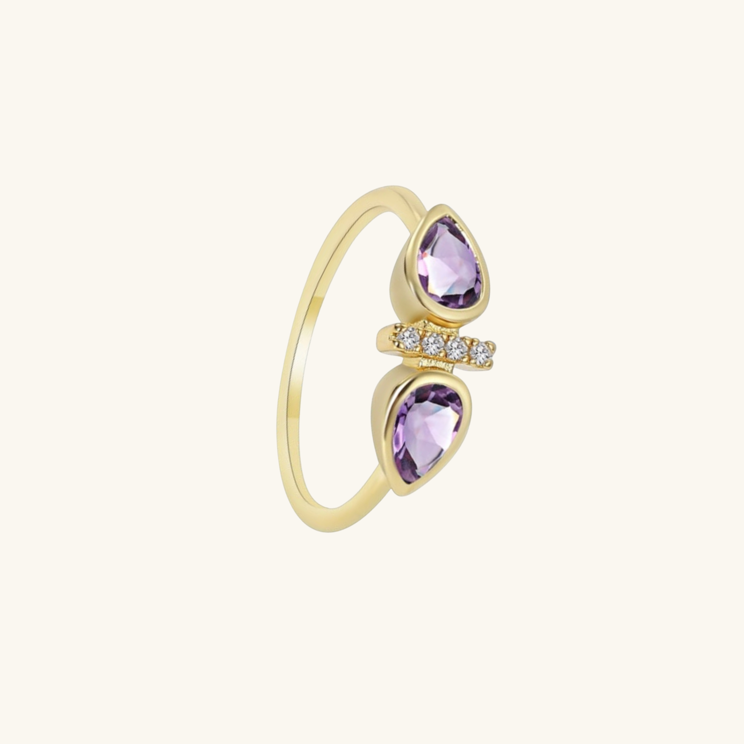 Gold ring with purple gemstones on a white background