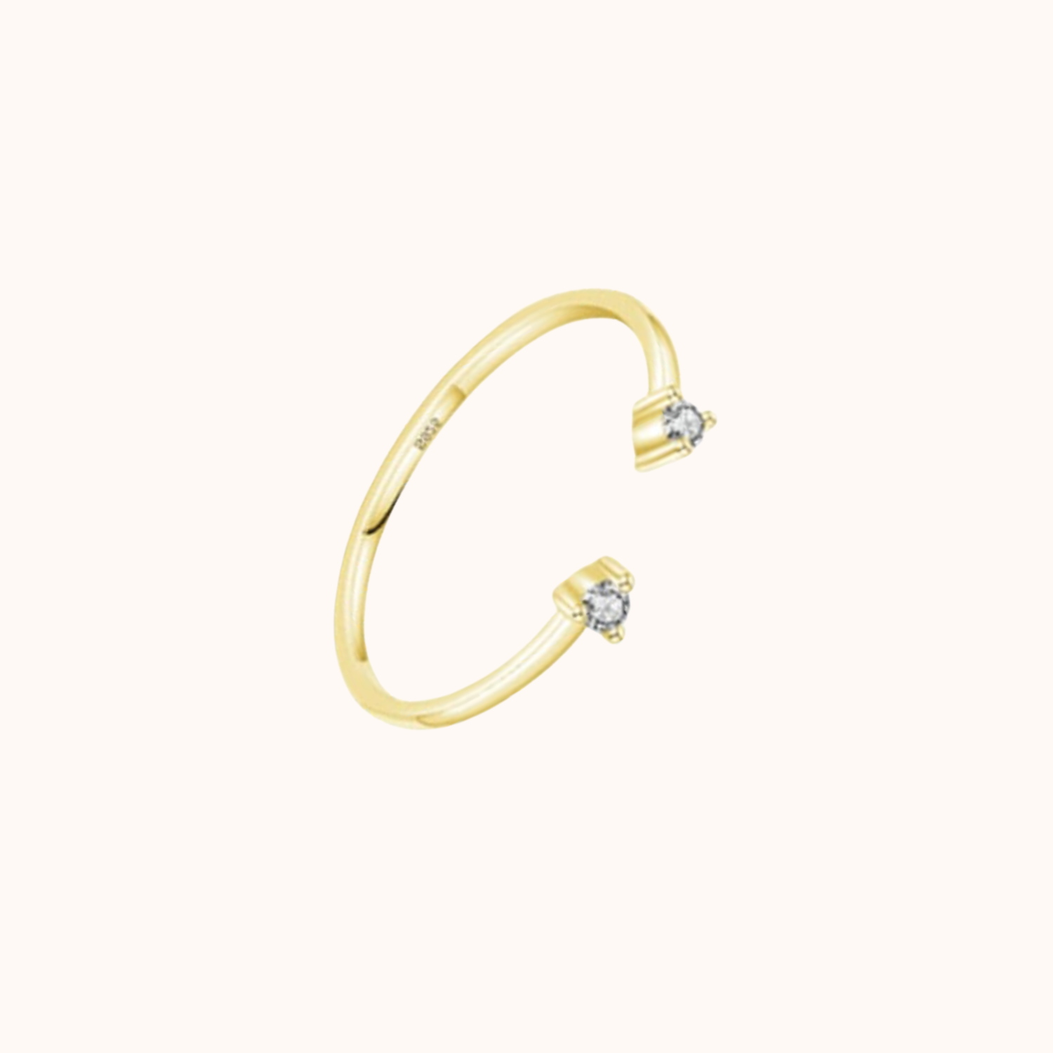 Gold ring with small cubic zirconia on a white background